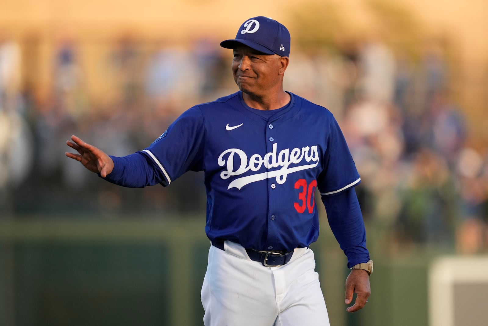 Los Angeles Dodgers manager Dave Roberts walks to the dugout before a spring training baseball game against the Los Angeles Angels, Friday, Feb. 28, 2025, in Phoenix. (AP Photo/Ashley Landis)