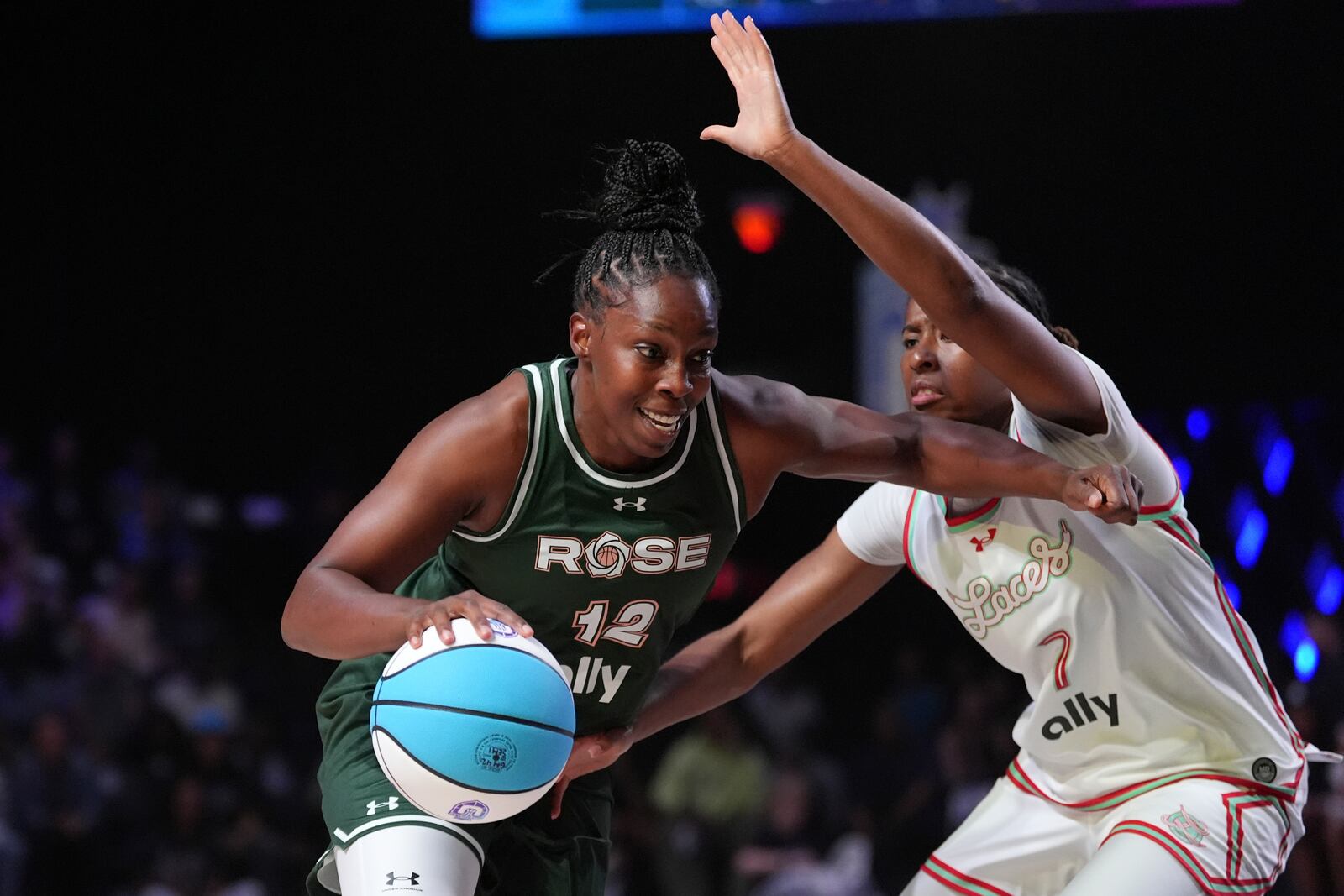 Rose guard Chelsea Gray powers past Laces guard Ariel Atkins in their Unrivaled 3-on-3 basketball semifinal, Sunday, March 16, 2025, in Medley, Fla. (AP Photo/Rebecca Blackwell)