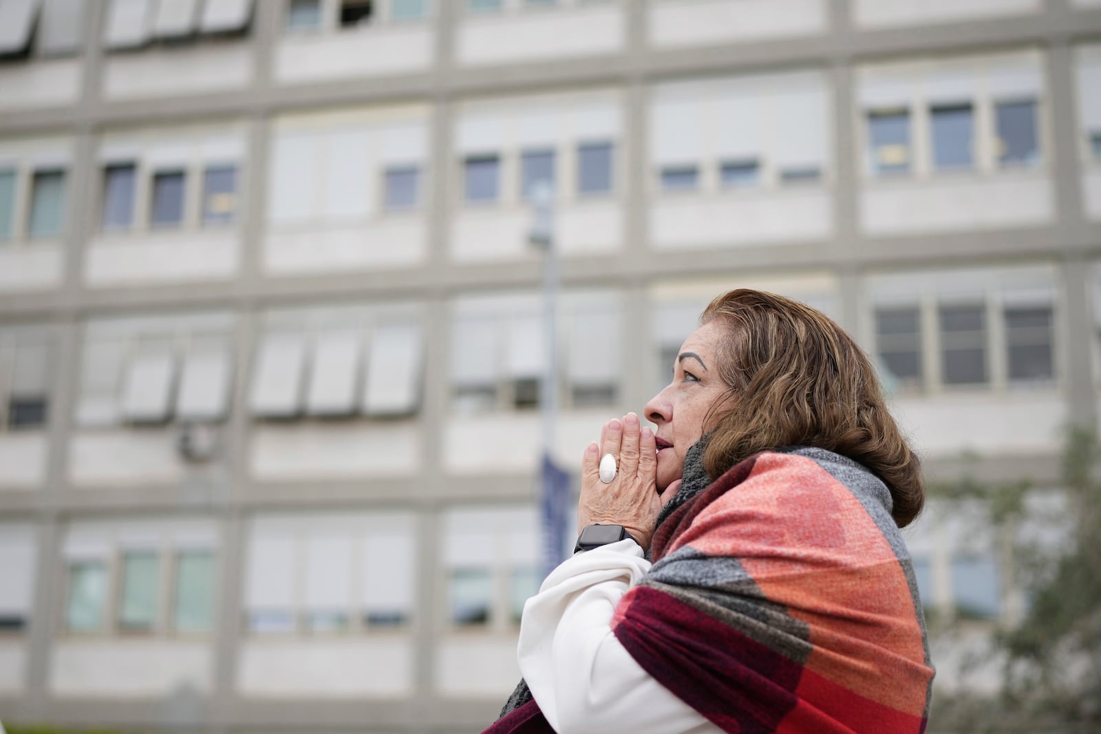 A woman prays at the Agostino Gemelli Polyclinic, in Rome, Monday, Feb. 24, 2025 where Pope Francis is hospitalized since Friday, Feb. 14. (AP Photo/Alessandra Tarantino)