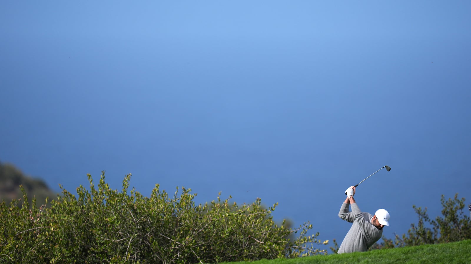 Scottie Scheffler hits a shot on the 14th hole of the South Course at Torrey Pines during the second round of the Genesis Invitational golf tournament Friday, Feb. 14, 2025, in San Diego. (AP Photo/Gregory Bull)