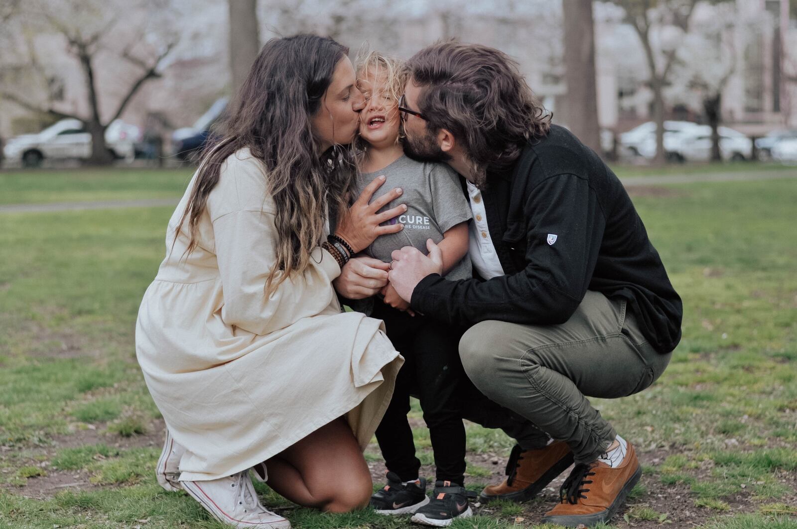 “Little Joy Boy,” as 5-year-old Fritz Krieger is called by his parents, Sarah and Bryant Krieger, gets a smooch from Mom and Dad. Fritz is battling Duchenne muscular dystrophy, the most progressive form of the disease. It has no cure. Sarah Krieger/CONTRIBUTED