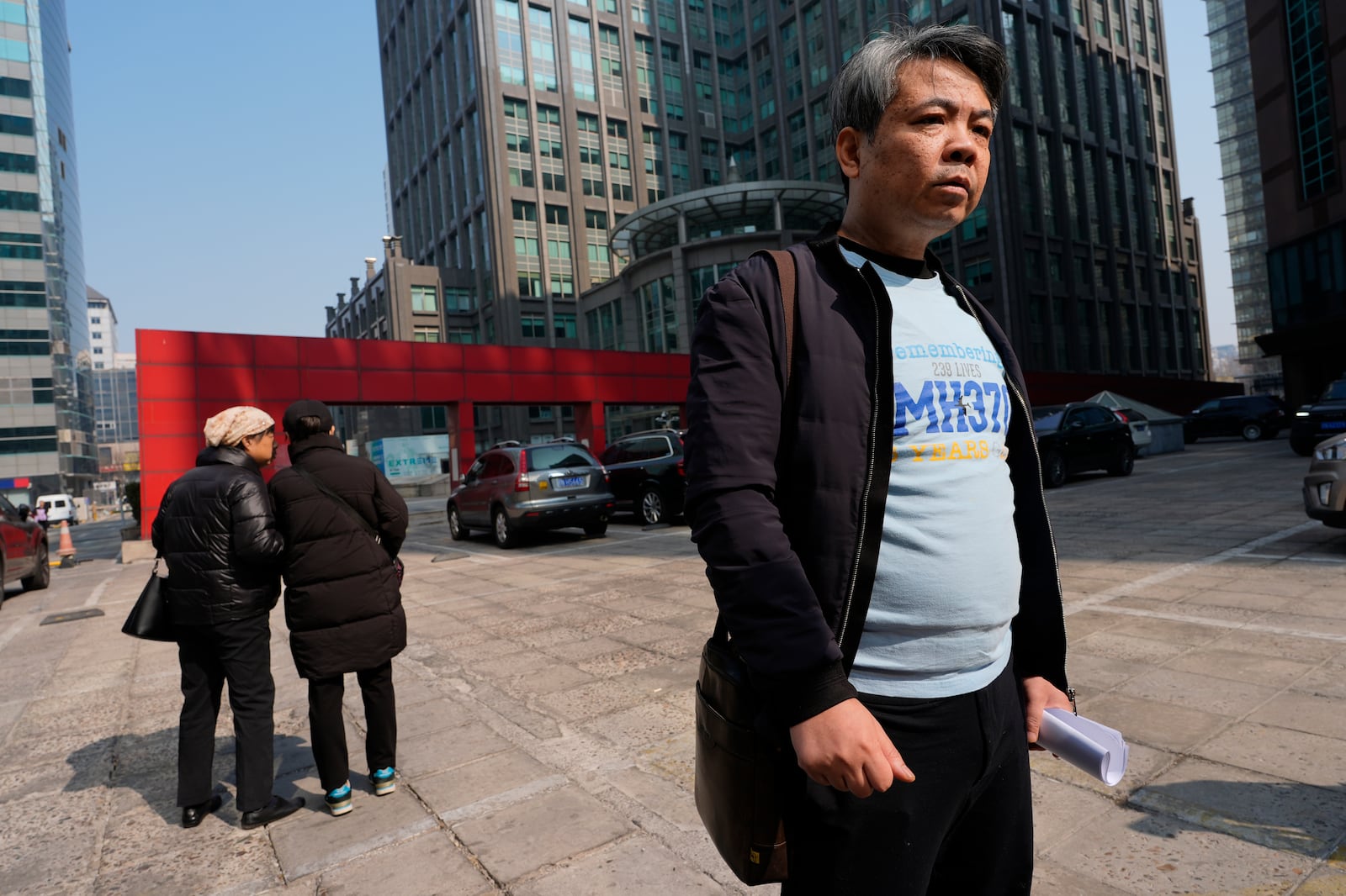 Jiang Hui, whose mother was on the missing MH370 Malaysia Airlines passenger jet, wears a shirt "Remembering 239 Lives, MH370" as he talks to media on the 11th anniversary of the jet going missing, Saturday, March 8, 2025, in Beijing, China. (AP Photo/Ng Han Guan)