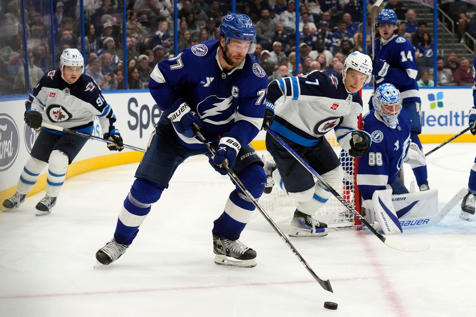 Tampa Bay Lightning defenseman Victor Hedman (77) moves the puck ahead of Winnipeg Jets center Vladislav Namestnikov (7) during the third period of an NHL hockey game Thursday, Nov. 14, 2024, in Tampa, Fla. (AP Photo/Chris O'Meara)