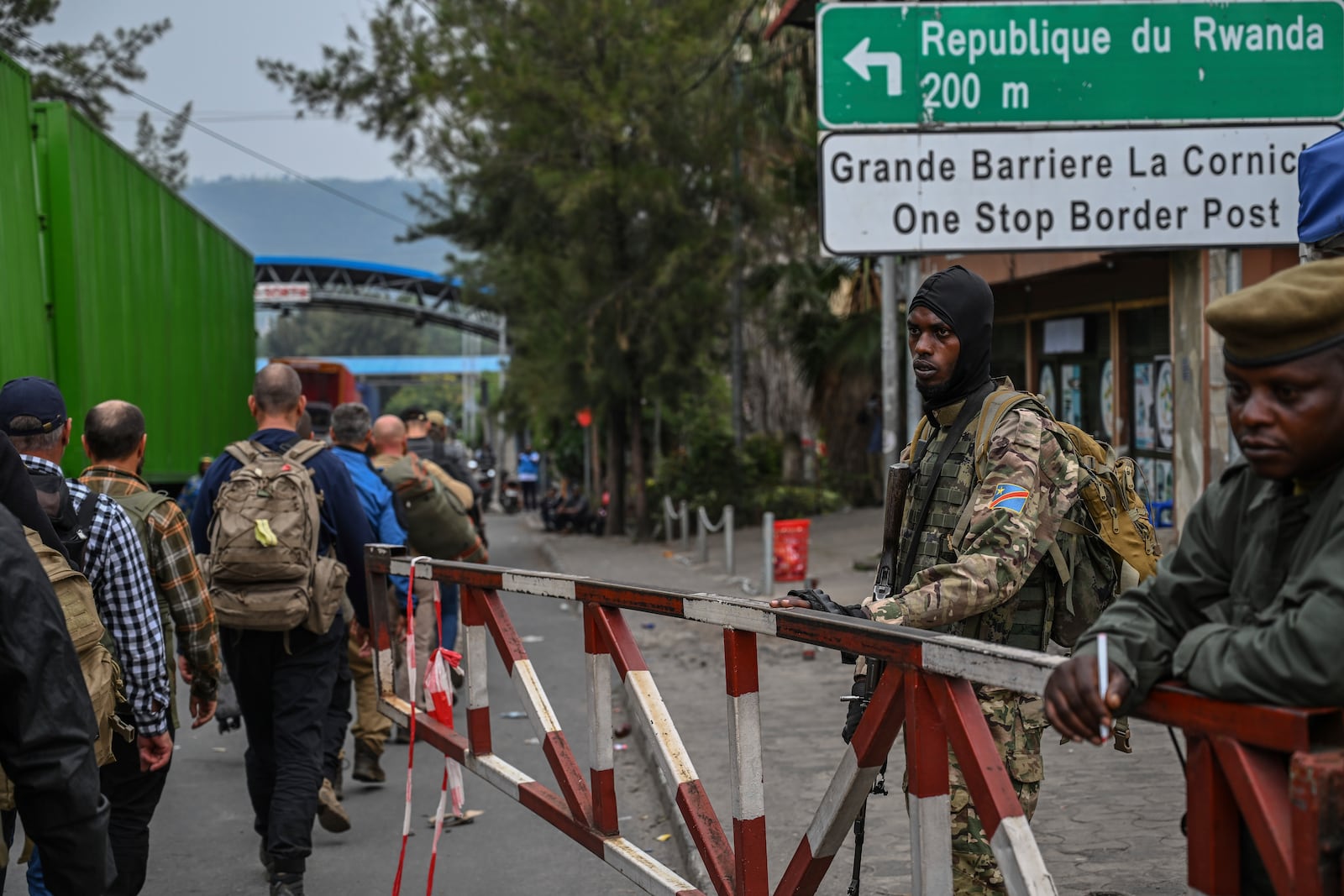 M23 rebels escort Romanian mercenaries to the border crossing into Rwanda in Goma, Democratic Republic of Congo, Wednesday, Jan. 29, 2025.(AP Photo/Moses Sawasawa)