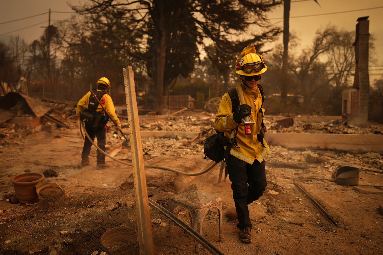 Firefighters looks for hot spots in a fire-ravaged property in the aftermath of the Eaton Fire Thursday, Jan. 9, 2025 in Altadena, Calif. (AP Photo/Eric Thayer)