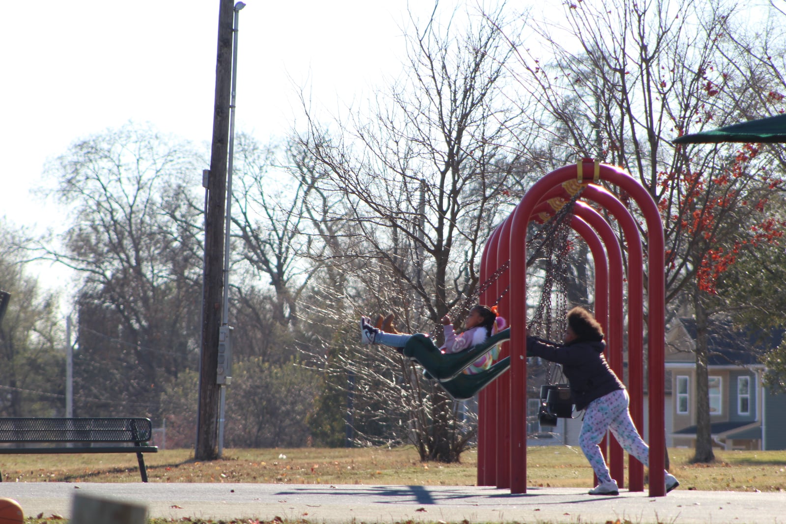 People enjoy the swings at McIntosh Park. CORNELIUS FROLIK / STAFF