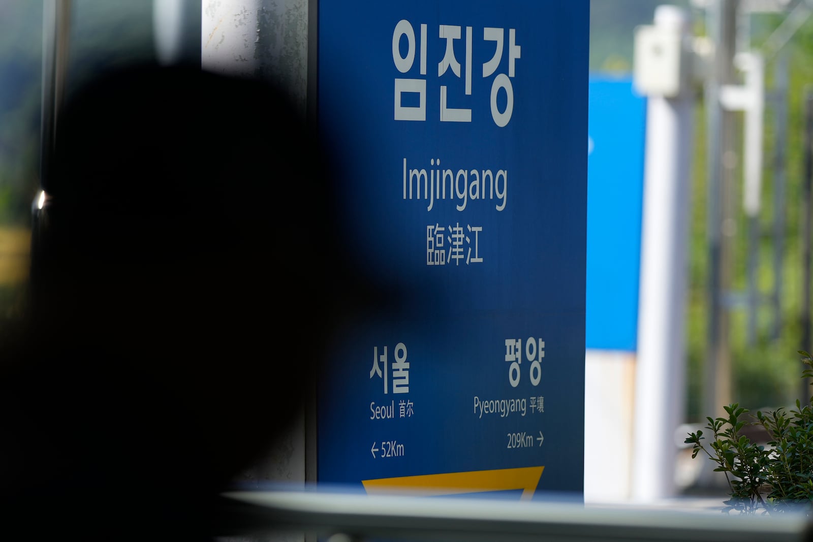 A visitor walks past near a signboard showing the distance to North Korea's capital Pyongyang and to South Korea's capital Seoul from Imjingang Station in Paju, South Korea, Wednesday, Oct. 9, 2024. (AP Photo/Lee Jin-man)