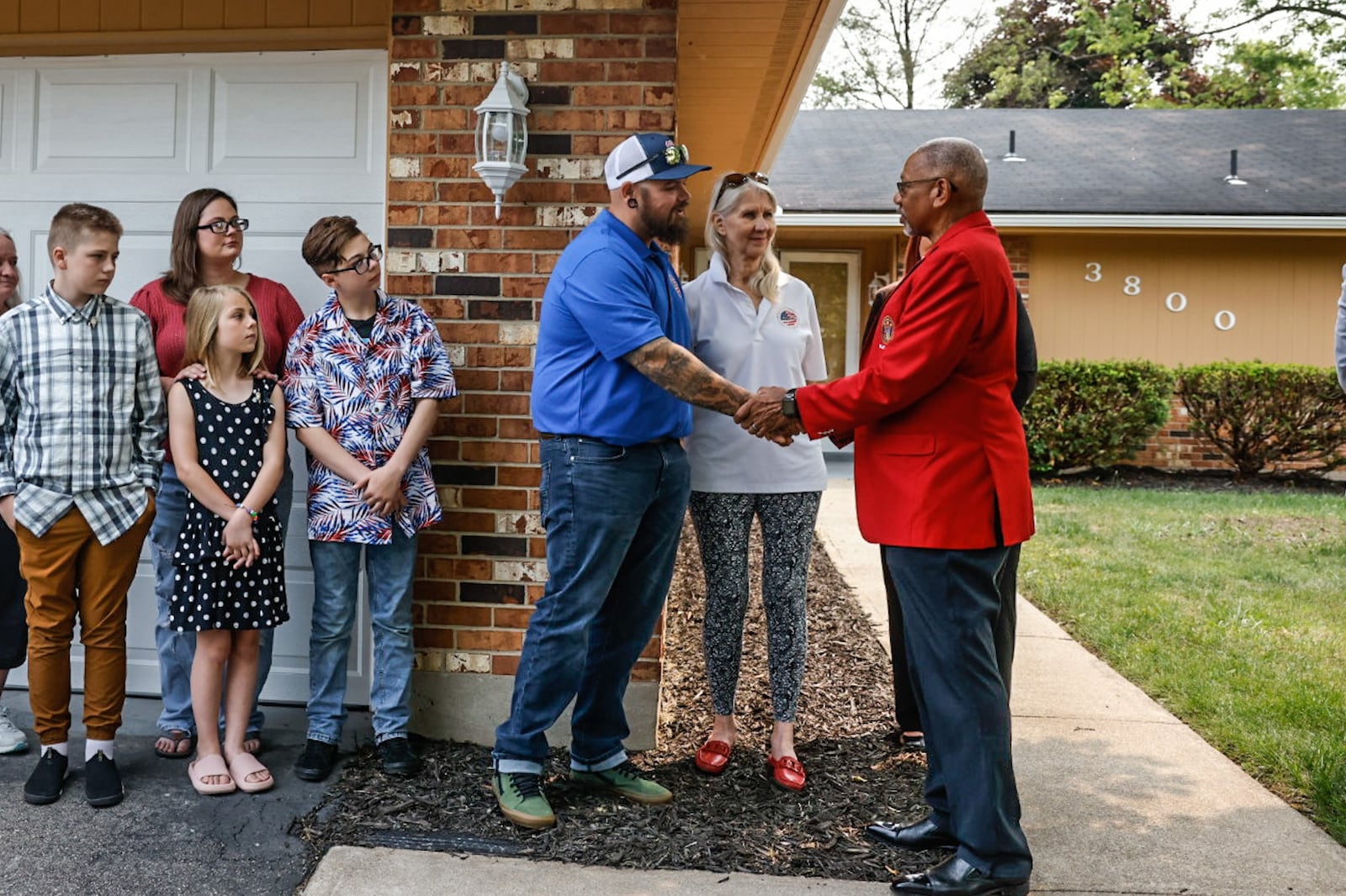 Army veteran Cody Blevins shakes Dayton Mayor Jeff Mims after receives the keys to his mortgage-free home Thursday June 15, 2023. The Blevins family received a mortgage-free home donated by Wells Fargo Bank and the Military Warriors Support Foundation. JIM NOELKER/STAFF