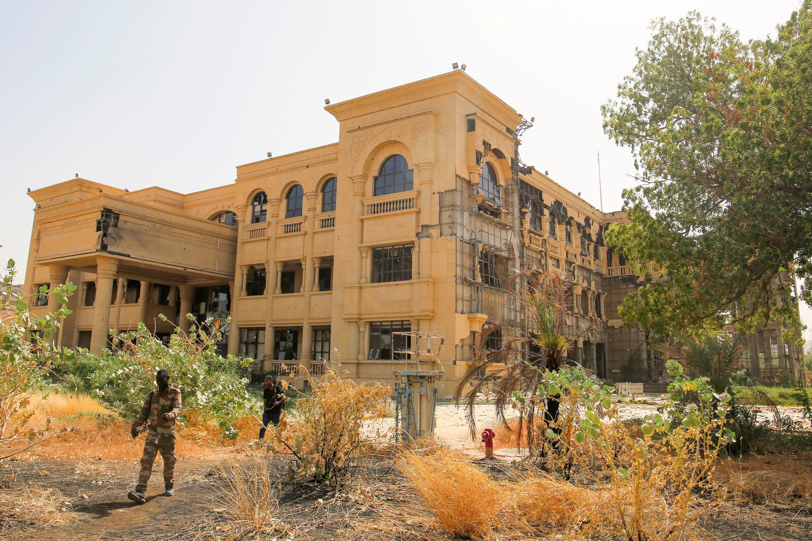 Army soldiers walk in front of the damaged Republican Palace in Khartoum, Sudan, after it was taken over by Sudan's army Friday, March 21, 2025. (AP Photo)