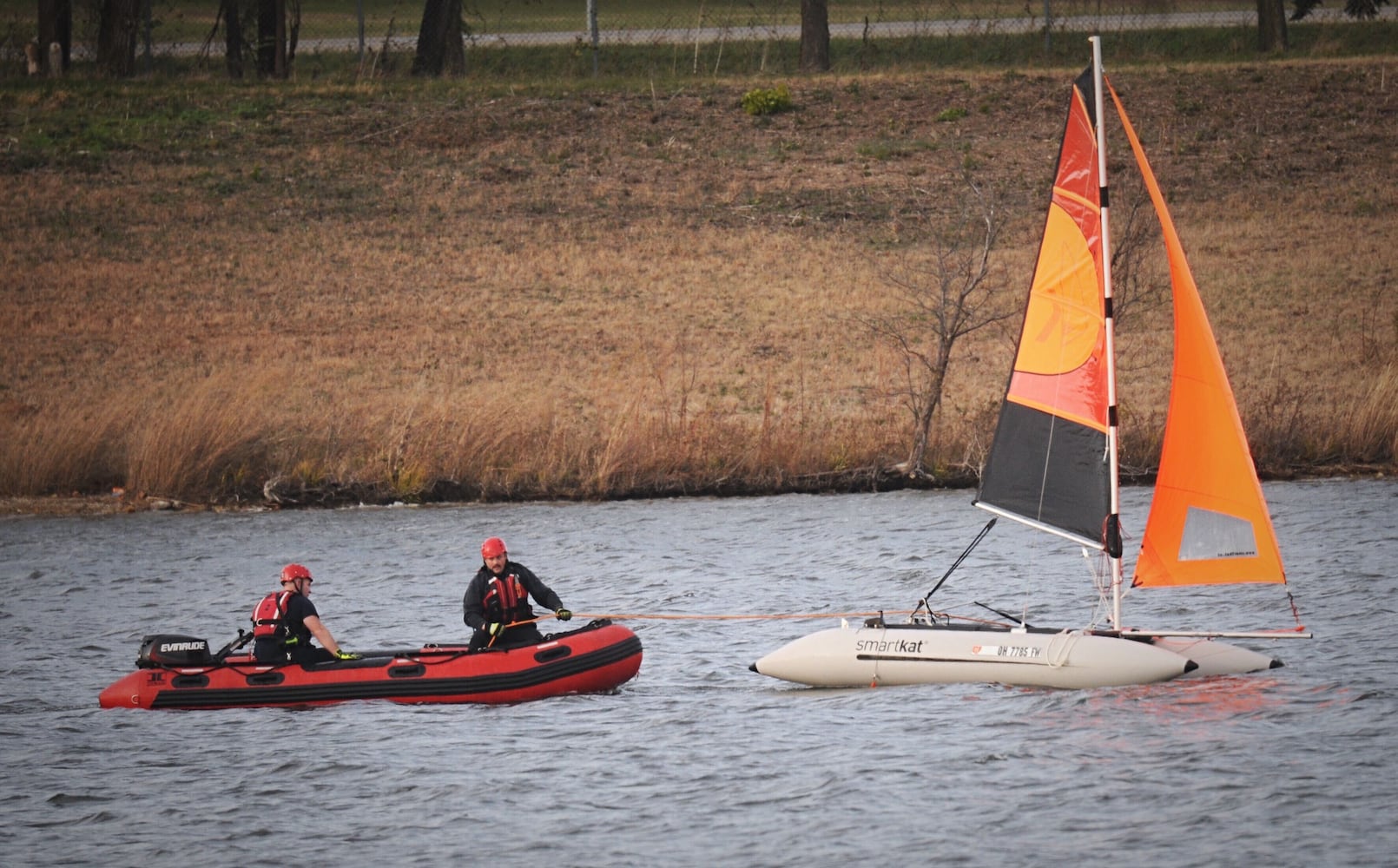 Man, dog rescued after boat overturns