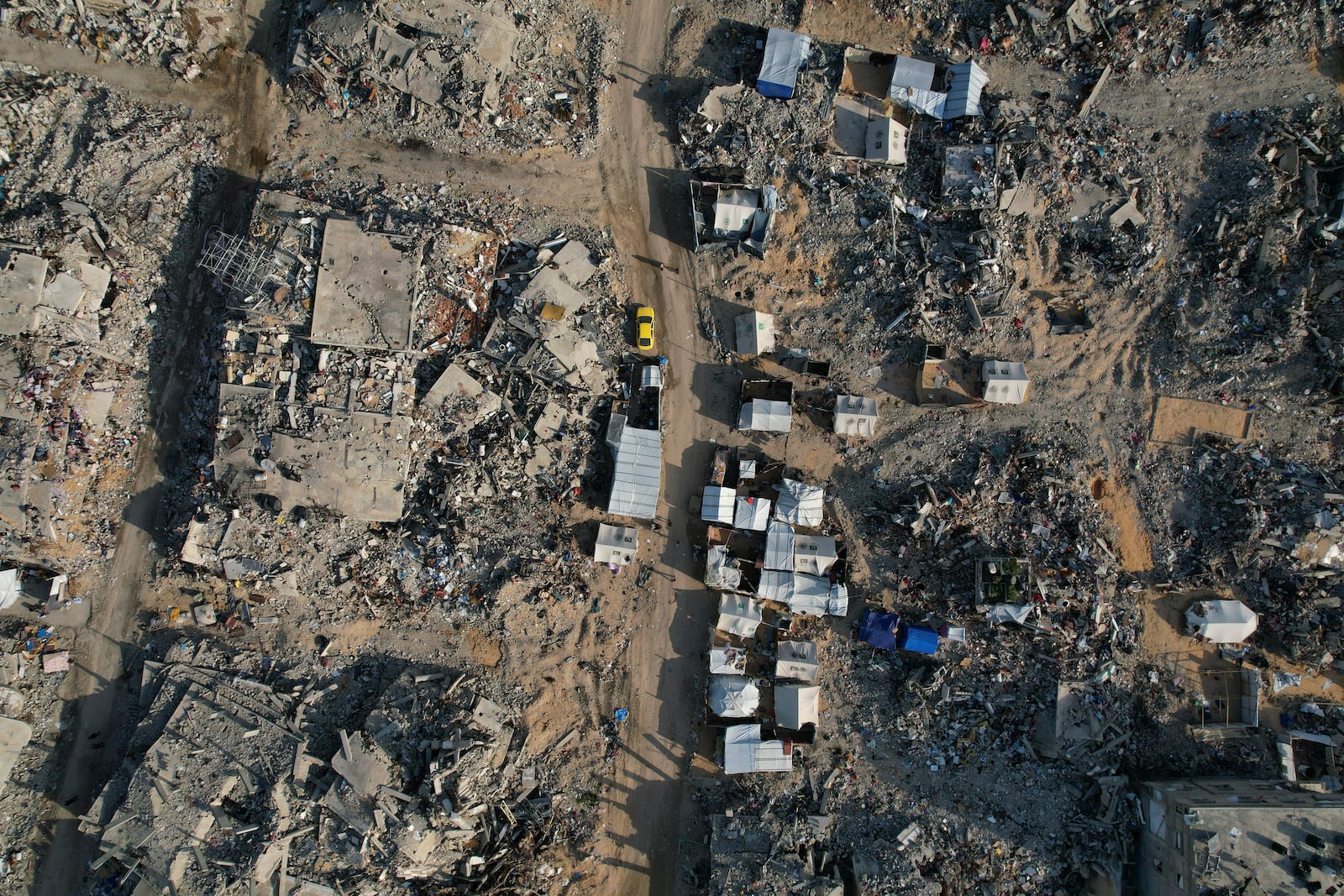 An aerial photograph taken by a drone shows tents amidst the destruction caused by the Israeli air and ground offensive in Beit Lahiya, northern Gaza Strip, on Monday, Feb. 17, 2025. (AP Photo/Mohammad Abu Samra)