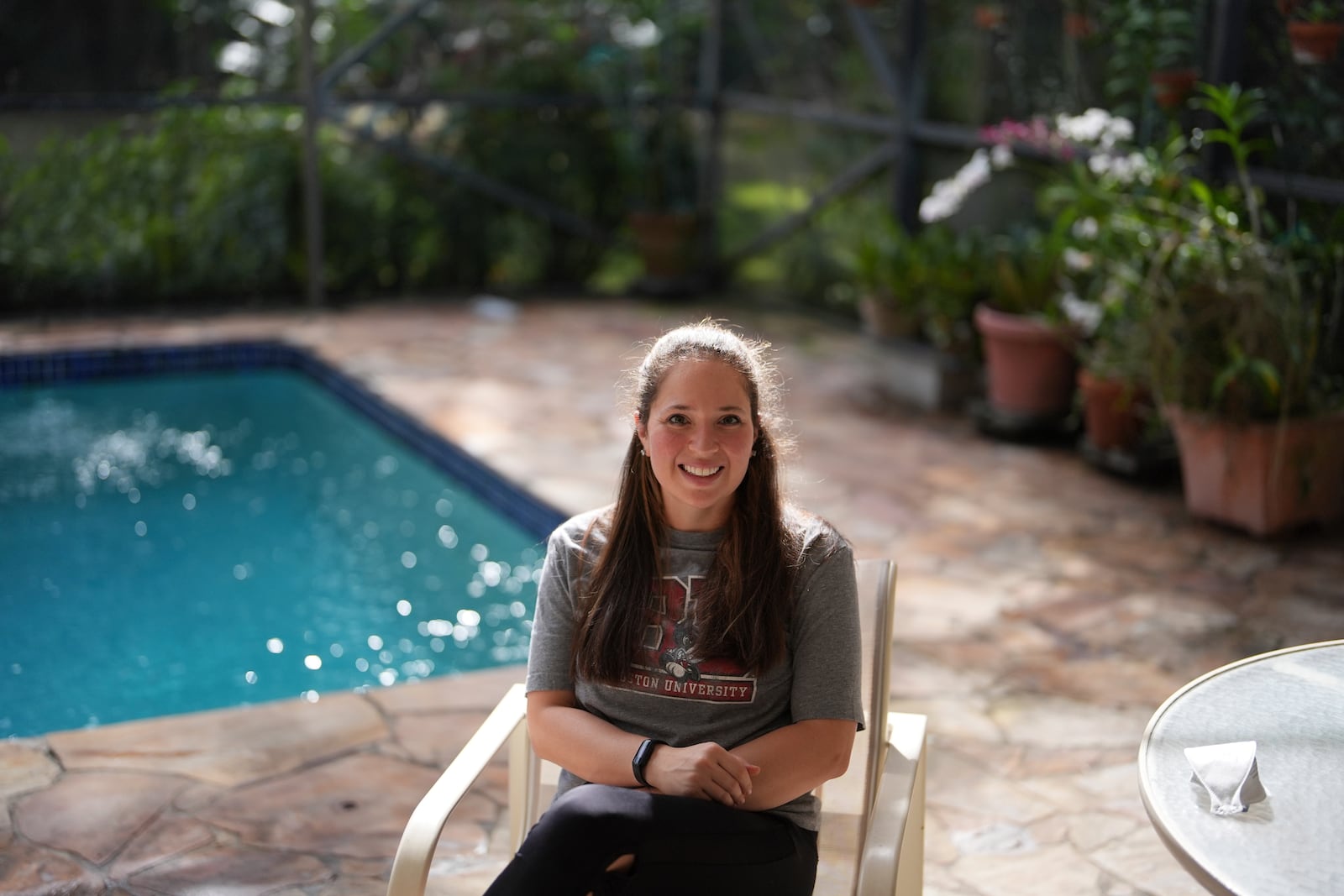 Kira Levin, 29, sits for a portrait outside the home where she lives with her parents and her 98-year-old grandmother, in Pinecrest, Fla., Monday, Dec. 16, 2024. Levin, who moved back in with her parents when COVID hit as she was finishing her masters degree, has become a primary caregiver to her grandmother while also working from home. (AP Photo/Rebecca Blackwell)