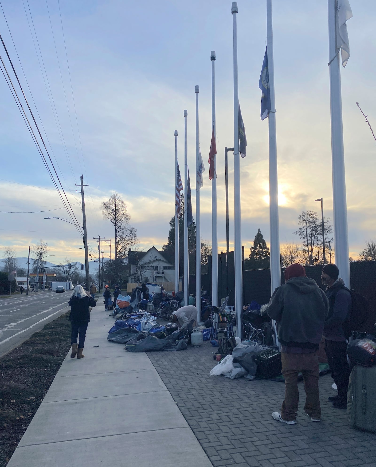 This image provided by the Oregon Law Center shows people waiting in Grants Pass, Ore. on Jan. 21, 2025 for a city-designated campsite for homeless people to open for its overnight hours. (Allison Nasson/Oregon Law Center via AP)