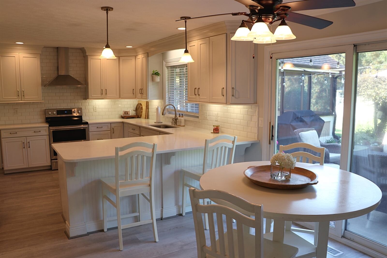 A peninsula counter divides the kitchen from the breakfast room, which has sliding patio doors that open to the backyard patio.