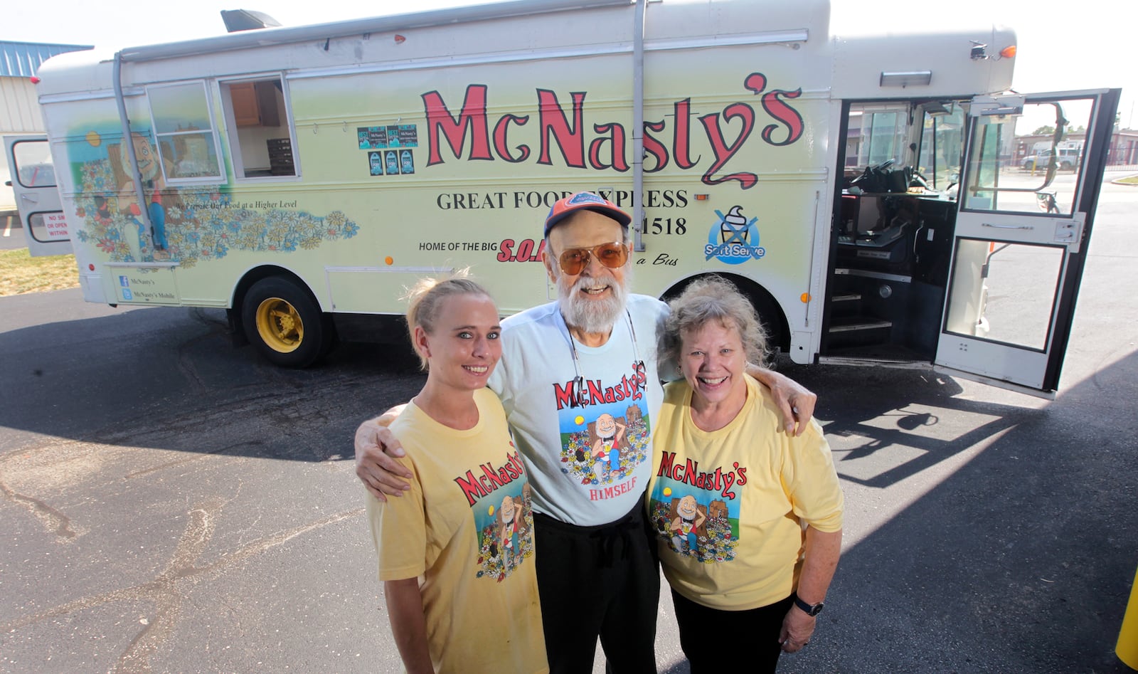 Dick and Cathy Bell are the owners of McNasty's food truck. At left is Shannon Johnson, an employee who works with the couple. The Bells will temporarily close the truck at the end of July "to take a break together," said Cathy. Dick has pancreatic cancer and said he only has months to live. LISA POWELL / STAFF