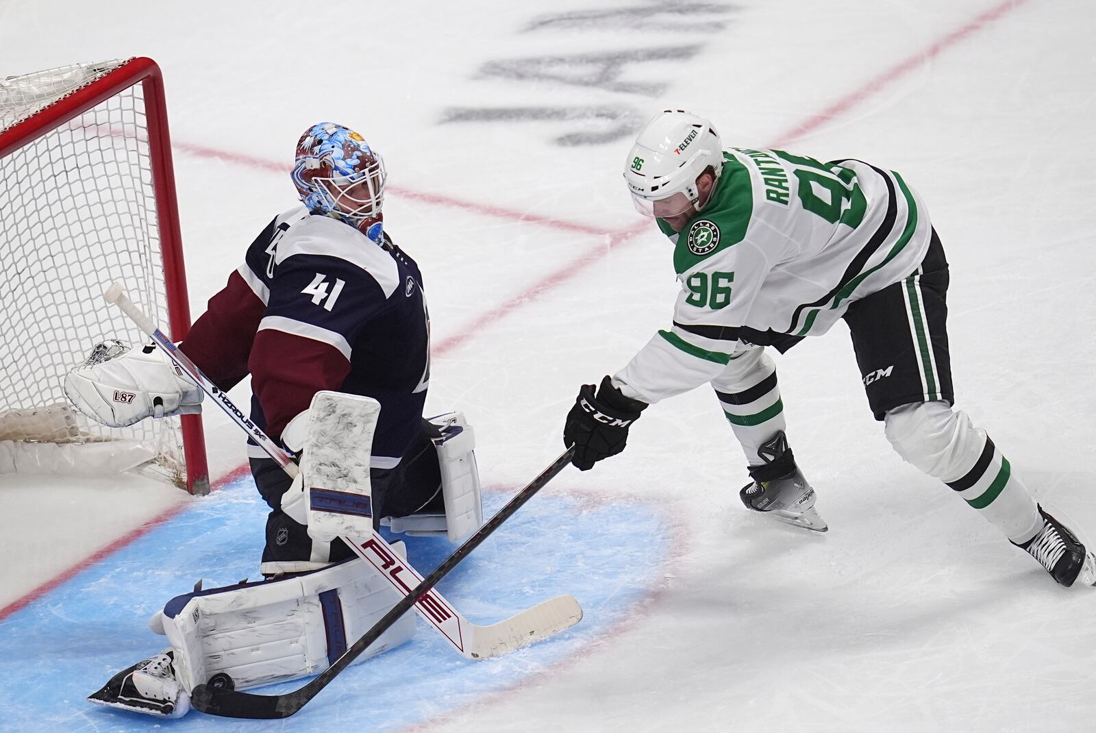 Colorado Avalanche goaltender Scott Wedgewood, left, makes a pad-save of a shot by Dallas Stars right wing Mikko Rantanen, right, in the third period of an NHL hockey game Sunday, March 16, 2025, in Denver. (AP Photo/David Zalubowski)