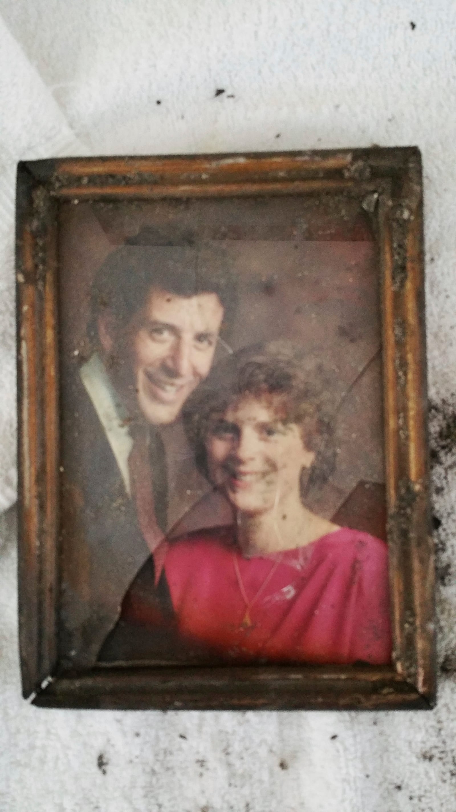 A photo recovered from the ashes of the Tecca family’s home shows Mark and Martha Tecca’s 1989 engagement photo. (Tecca family via AP)