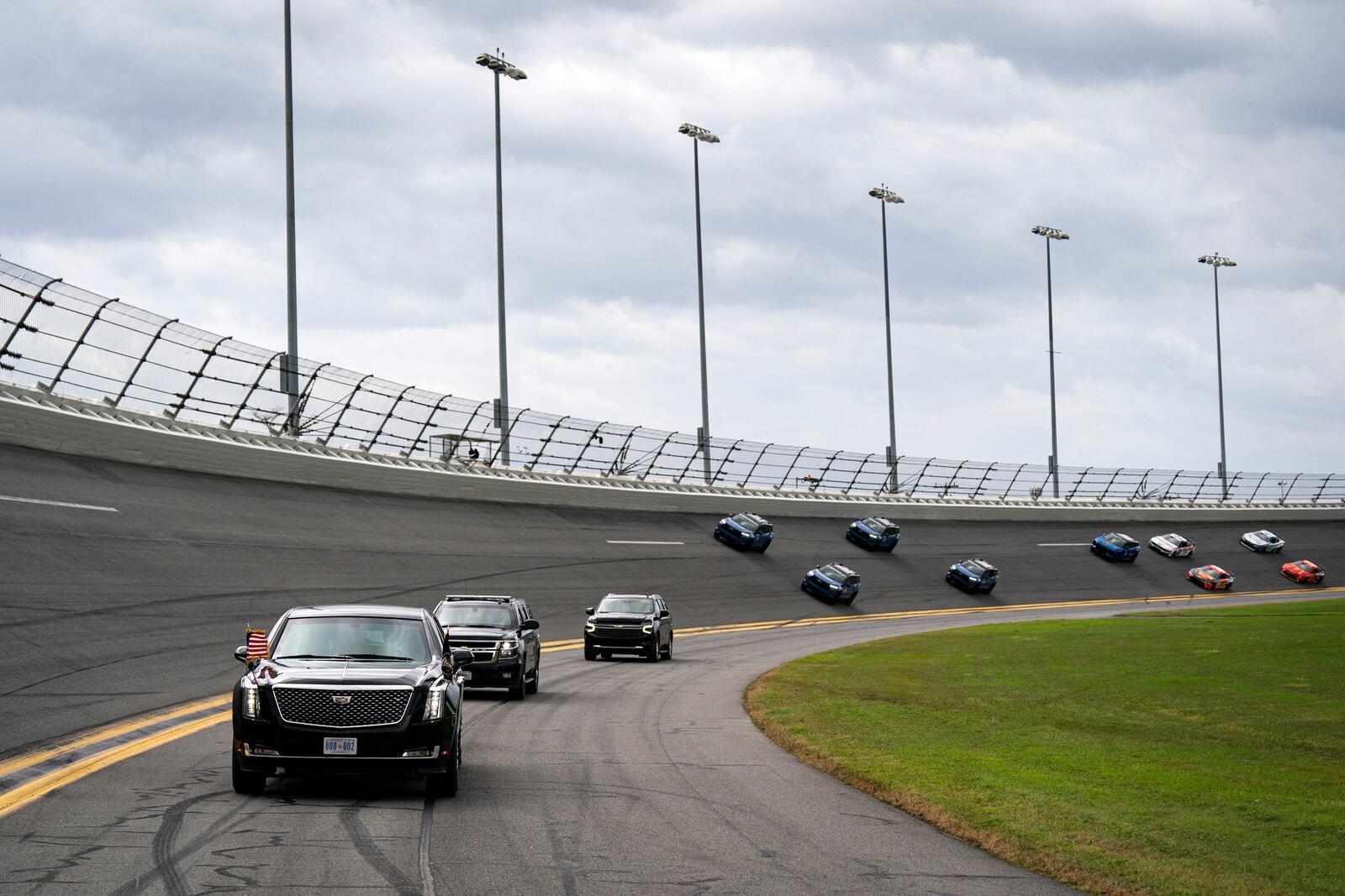 President Donald Trump rides in the presidential limousine known as "The Beast" as he takes a pace lap ahead of the start of the NASCAR Daytona 500 auto race at Daytona International Speedway, Sunday, Feb. 16, 2025, in Daytona Beach, Fla. (Pool via AP)