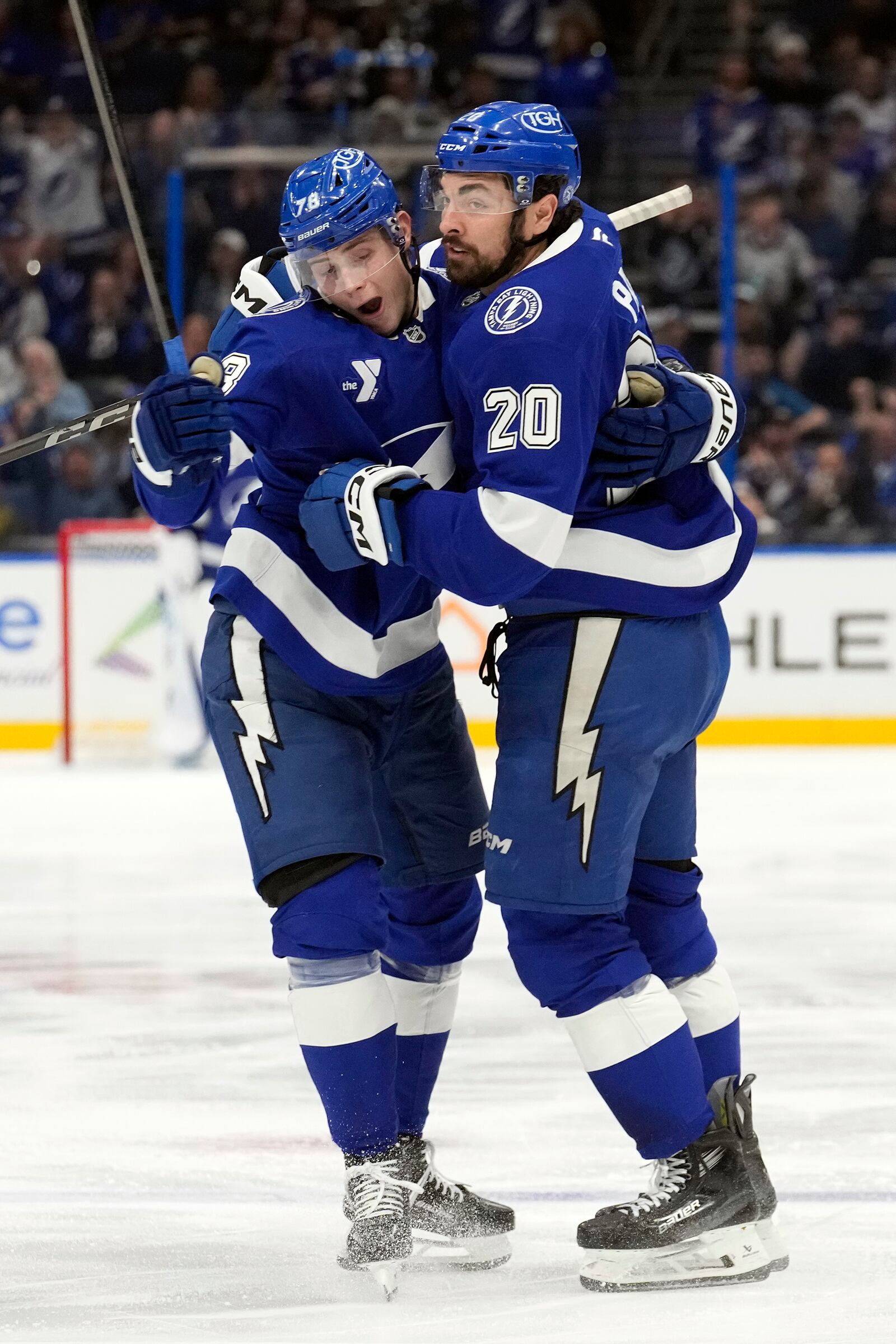 Tampa Bay Lightning left wing Nick Paul (20) celebrates his goal against the Columbus Blue Jackets with defenseman Emil Lilleberg (78) during the second period of an NHL hockey game Tuesday, Dec. 17, 2024, in Tampa, Fla. (AP Photo/Chris O'Meara)