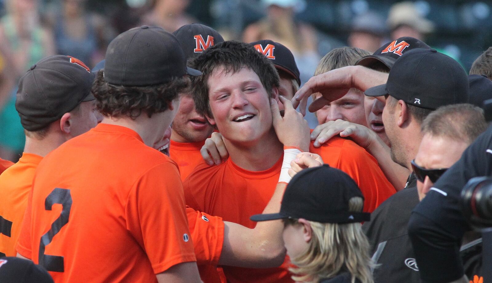 Minster celebrates Jon Niemeyer’s walkoff single against Russia. David Jablonski/Staff