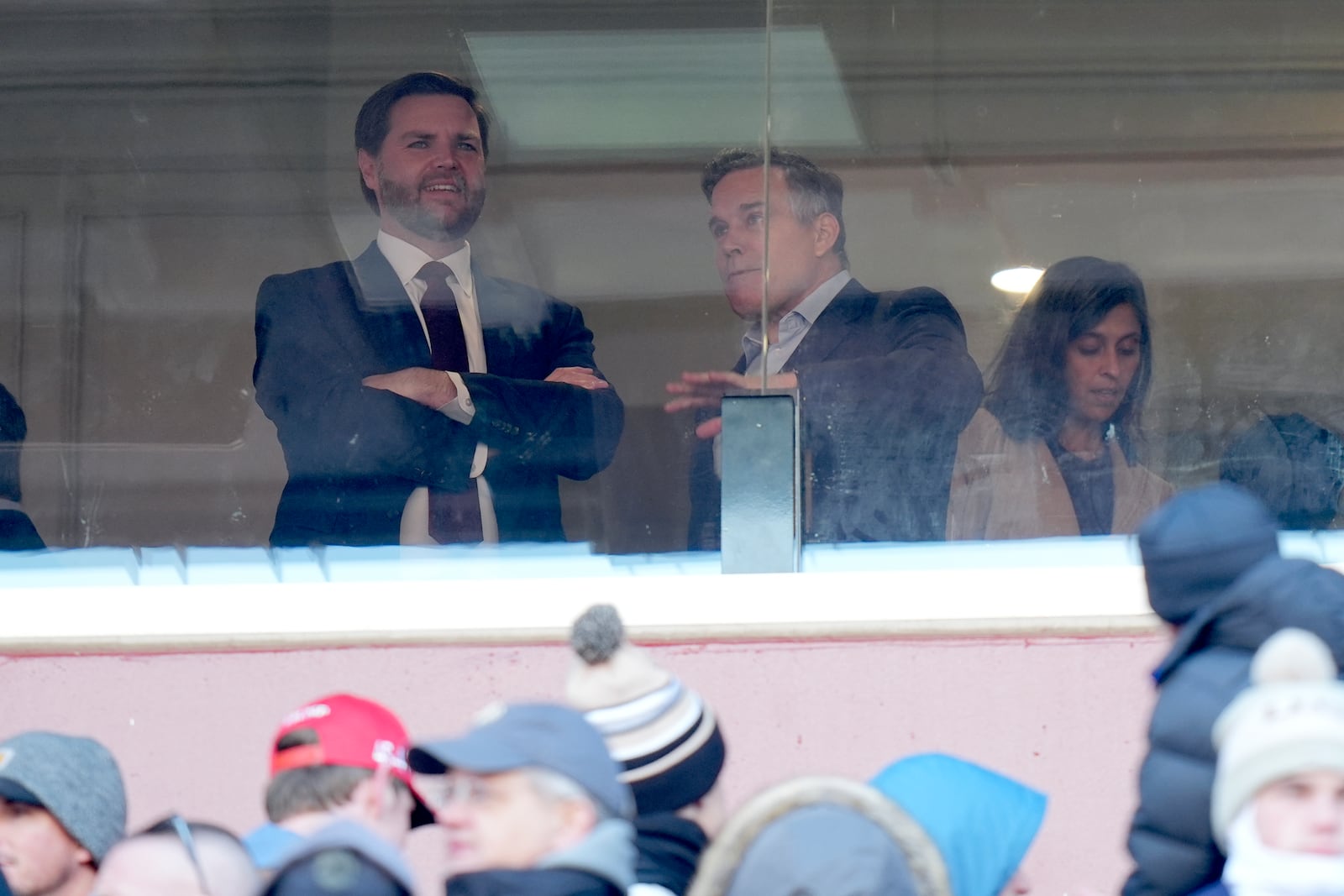 Vice President-elect JD Vance, from left, and Senator-elect Dave McCormick, R-Pa., speak as Usha Vance looks on at the NCAA college football game between Army and Navy at Northwest Stadium in Landover, Md., Saturday, Dec. 14, 2024. (AP Photo/Stephanie Scarbrough)