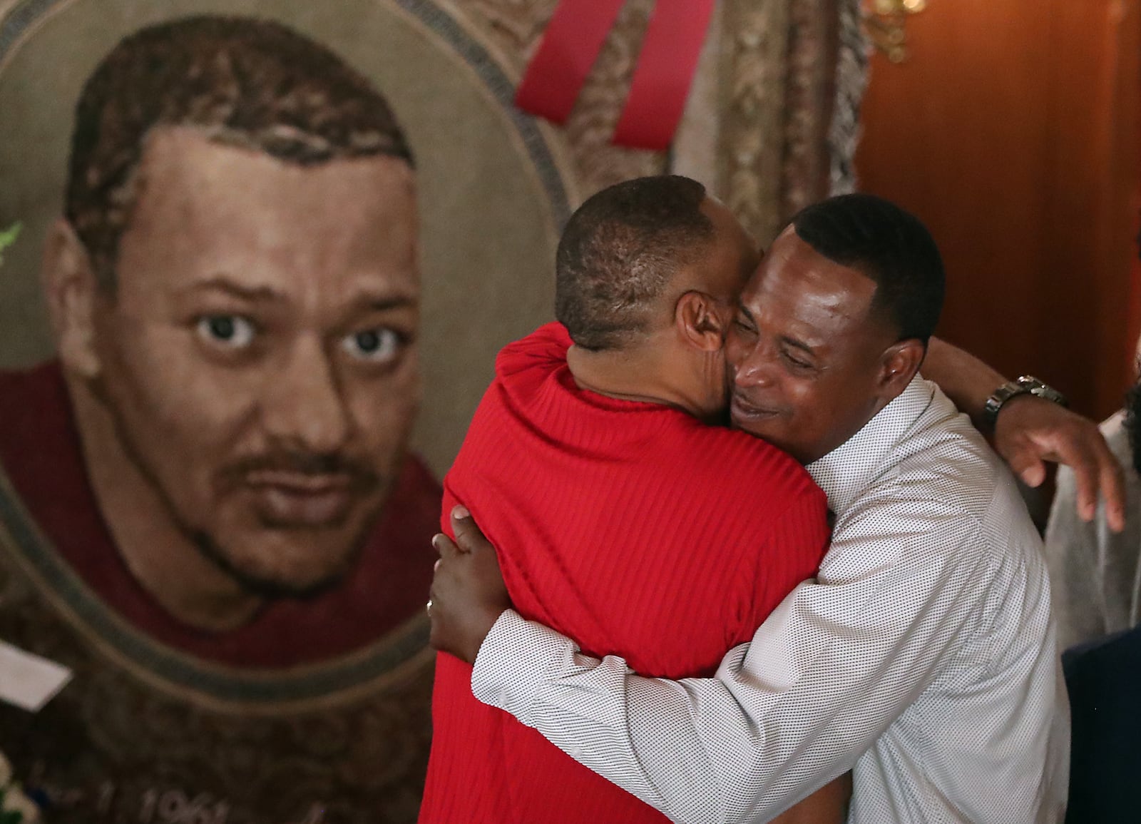 Family members and friends console each other Saturday during the funeral service for Derrick Fudge, who was killed in the Oregon District mass shooting last Sunday. BILL LACKEY/STAFF