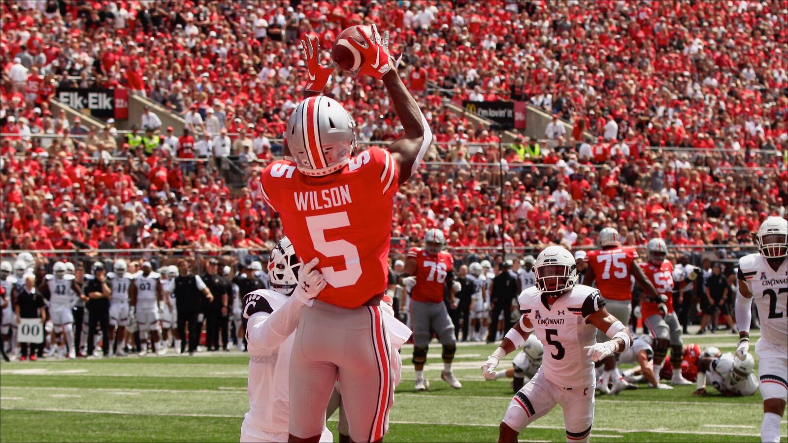 Ohio State's Garrett Wilson catches a touchdown pass against Cincinnati on Saturday, Sept. 7, 2019, at Ohio Stadium in Columbus. The Big Ten and Pac-12, home to schools like Ohio State University and the University of Oregon, joined smaller conferences this week that have put off a return to play this season due to the coronavirus pandemic. David Jablonski / Staff