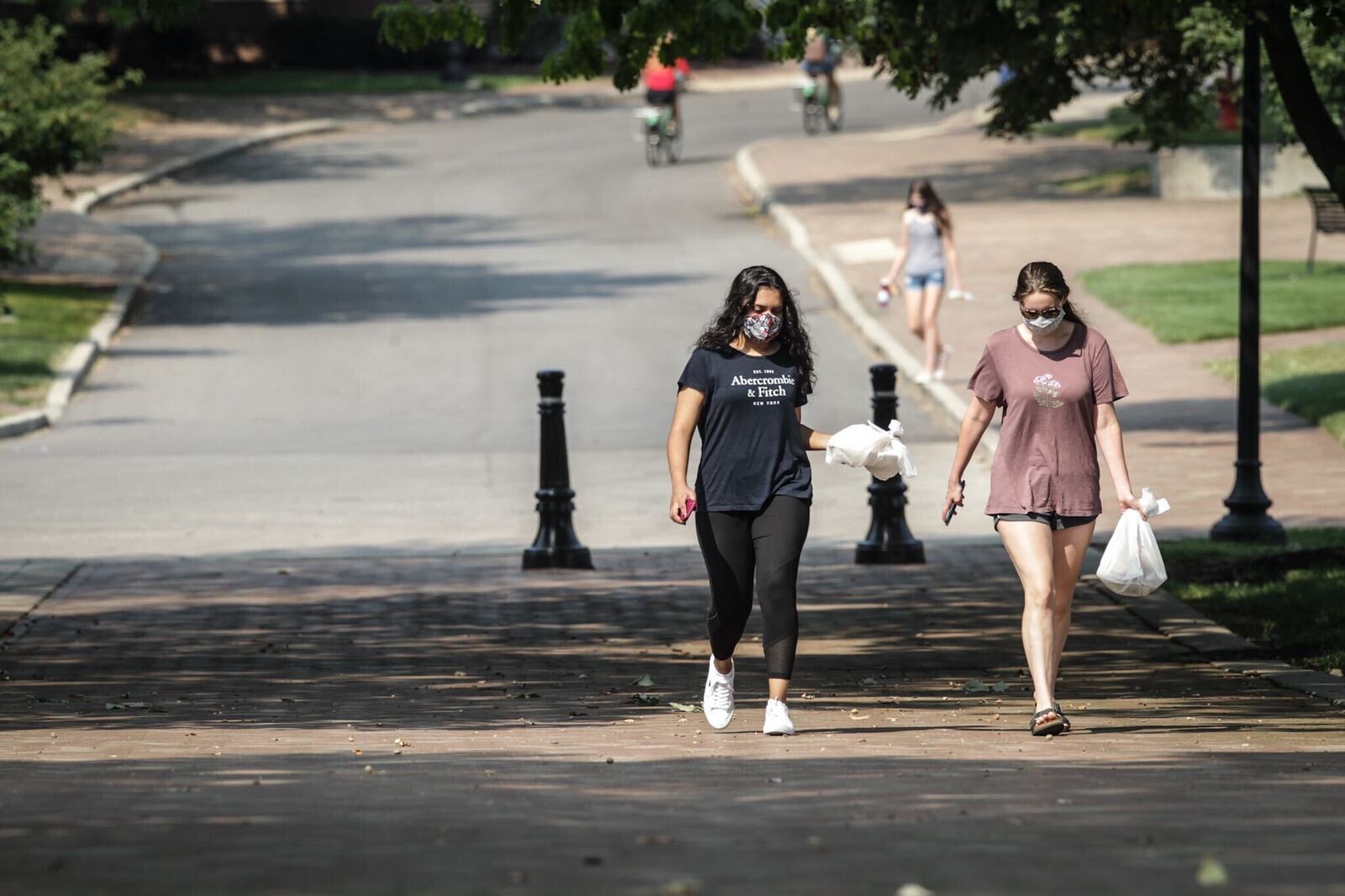 Ayesha Sheikh, left and Brooke Baker, both sophomores at the University of Dayton, walk to class with few other students during the COVID-19 outbreak Wednesday August 26, 2020. Jim Noelker/Staff