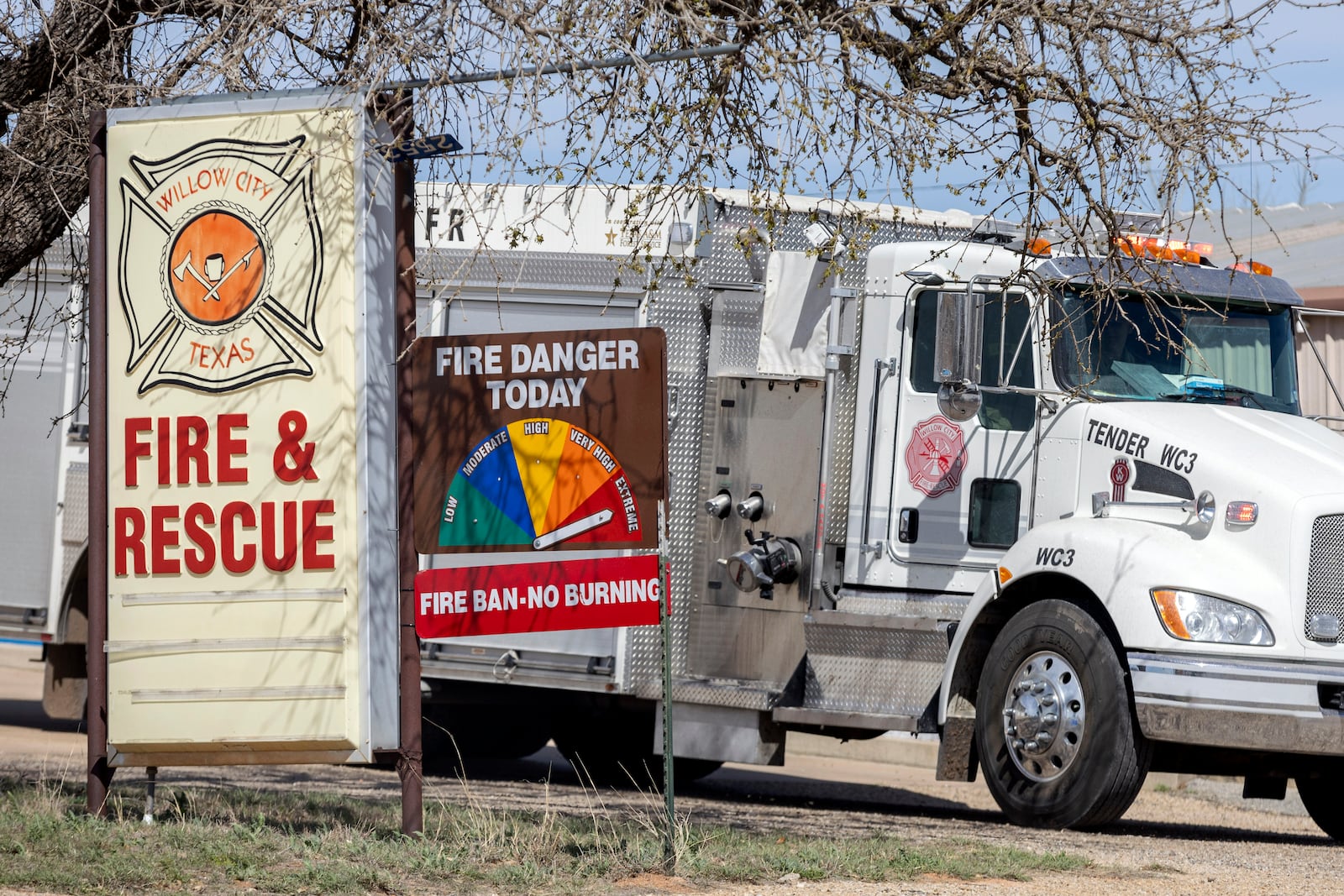 Outside the Willow City Volunteer Fire and Rescue, headquarters for crews battling the Crabapple Fire, the fire danger sign indicates extreme danger on Monday, March 17, 2025, in Willow City, Texas. (Josie Norris/The San Antonio Express-News via AP)