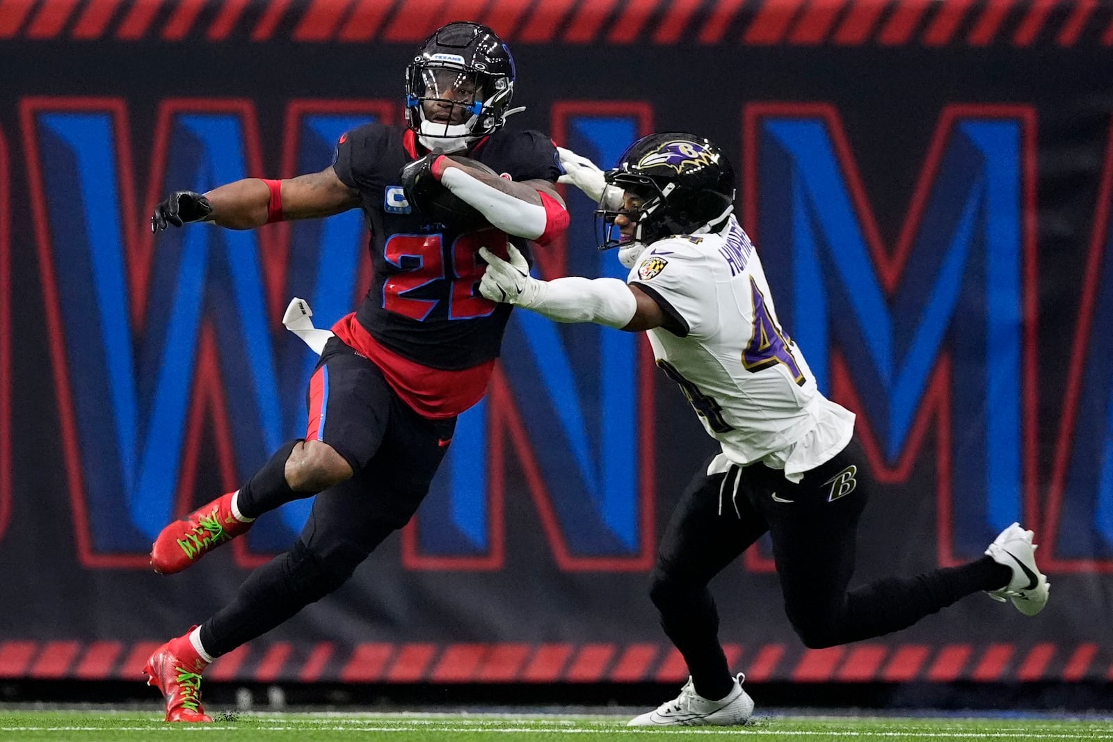 Houston Texans running back Joe Mixon (28) catches a pass in front of Baltimore Ravens cornerback Marlon Humphrey (44) during the first half of an NFL football game, Wednesday, Dec. 25, 2024, in Houston. (AP Photo/Eric Christian Smith)