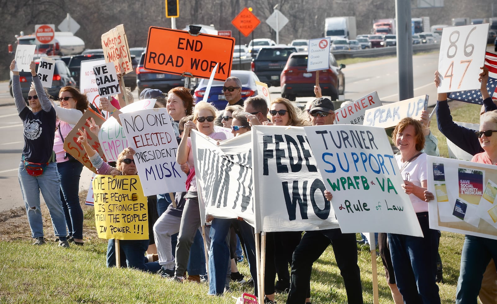 More than 100 people gathered along U.S. 35 in Beavercreek to protest against the actions of DOGE, March 18, 2025. MARSHALL GORBY/STAFF