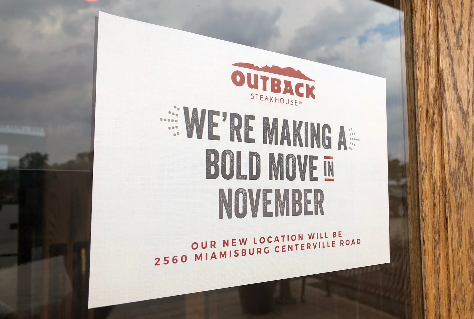 Customers of the Outback Steakhouse in the Cross Pointe Center are greeted with a sign informing them the restaurant will move to the Dayton Mall.