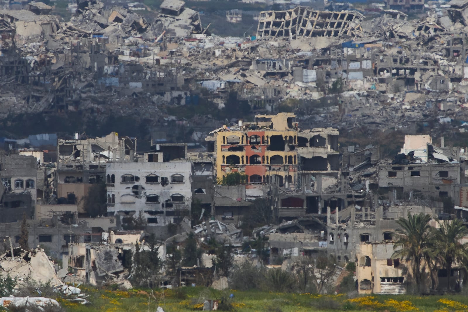 A view of destroyed buildings by Israeli bombardments in the northern Gaza Strip as seen from southern Israel, Wednesday, March 19, 2025. (AP Photo/Ariel Schalit)