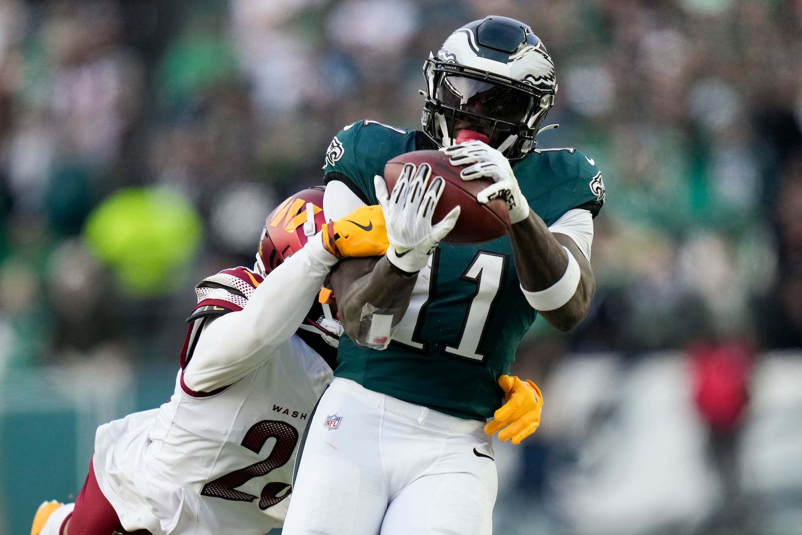 Philadelphia Eagles wide receiver A.J. Brown catches a pass ahead of Washington Commanders cornerback Marshon Lattimore during the first half of the NFC Championship NFL football game, Sunday, Jan. 26, 2025, in Philadelphia. (AP Photo/Seth Wenig)