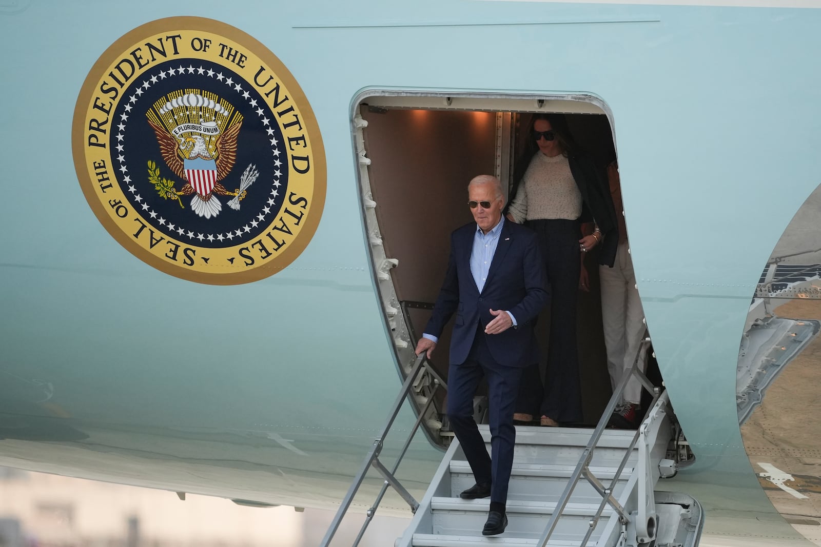 U.S. President Joe Biden deplanes in Lima, Peru, to attend the Asia-Pacific Economic Cooperation (APEC) summit, in Lima, Peru, Thursday, Nov. 14, 2024. (AP Photo/Guadalupe Pardo)