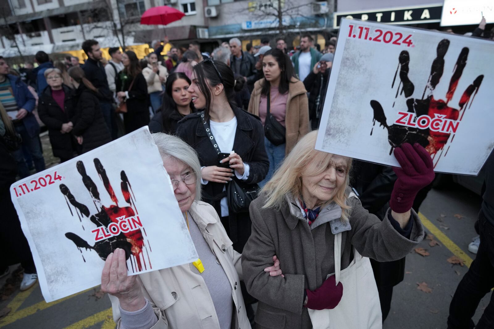 People attend a protest, a day after the assault on students was carried out by thugs with baseball bats, in Novi Sad, Serbia, Tuesday, Jan. 28, 2025. (AP Photo/Darko Vojinovic)