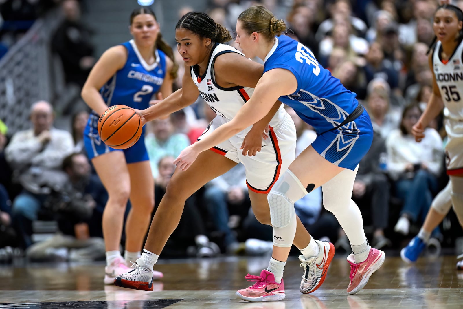 UConn forward Sarah Strong, left, steals the ball from Creighton guard Morgan Maly in the first half of an NCAA college basketball game, Thursday, Feb. 27, 2025, in Hartford, Conn. (AP Photo/Jessica Hill)