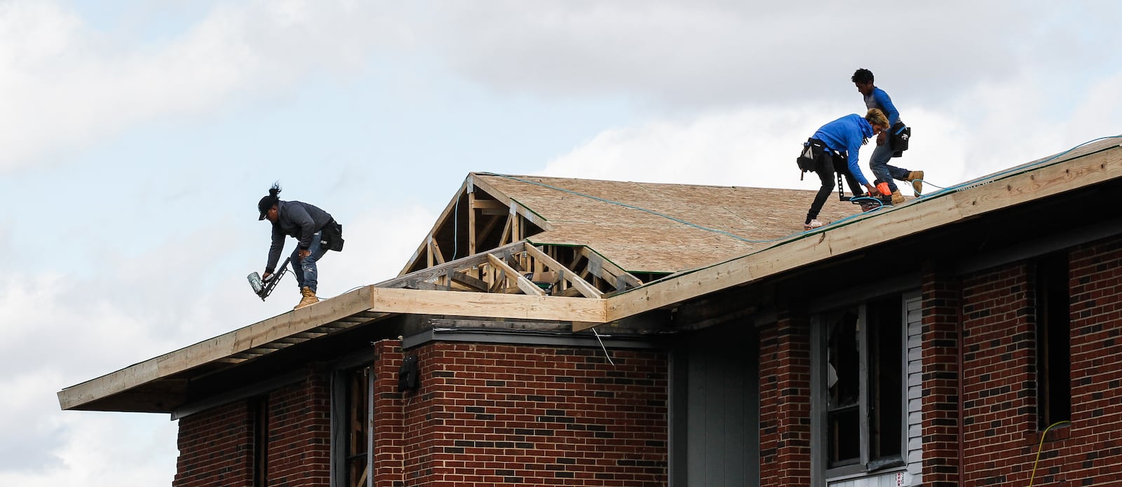 Workers put a new roof on a building at Westbrooke Village Apartments in Trotwood where hundreds of renters lived before a powerful EF4 tornado destroyed a majority of the complex. CHRIS STEWART / STAFF