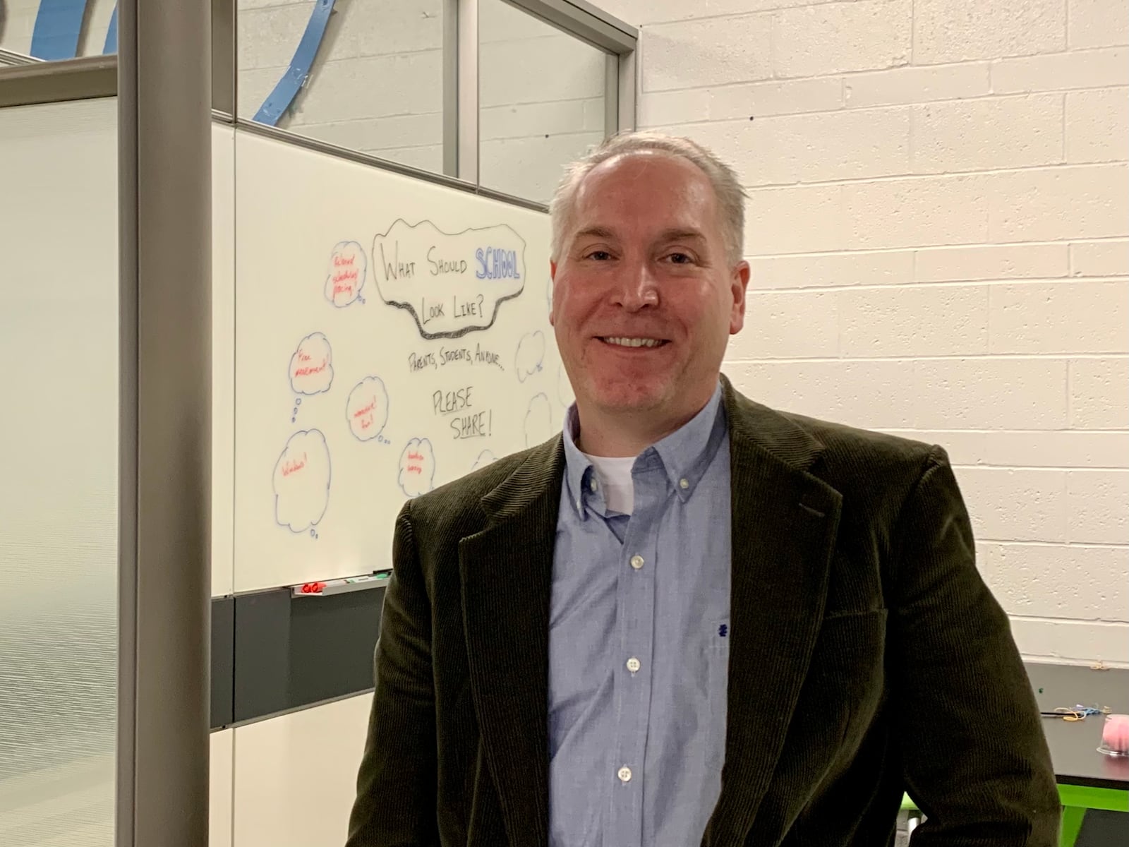 Dr. Jeremy Ervin smiles in a classroom created with adaptable walls developed by Canada-based company DIRTT, which are durable, soundproof, and can be used to create whole new classrooms practically overnight. LONDON BISHOP/STAFF