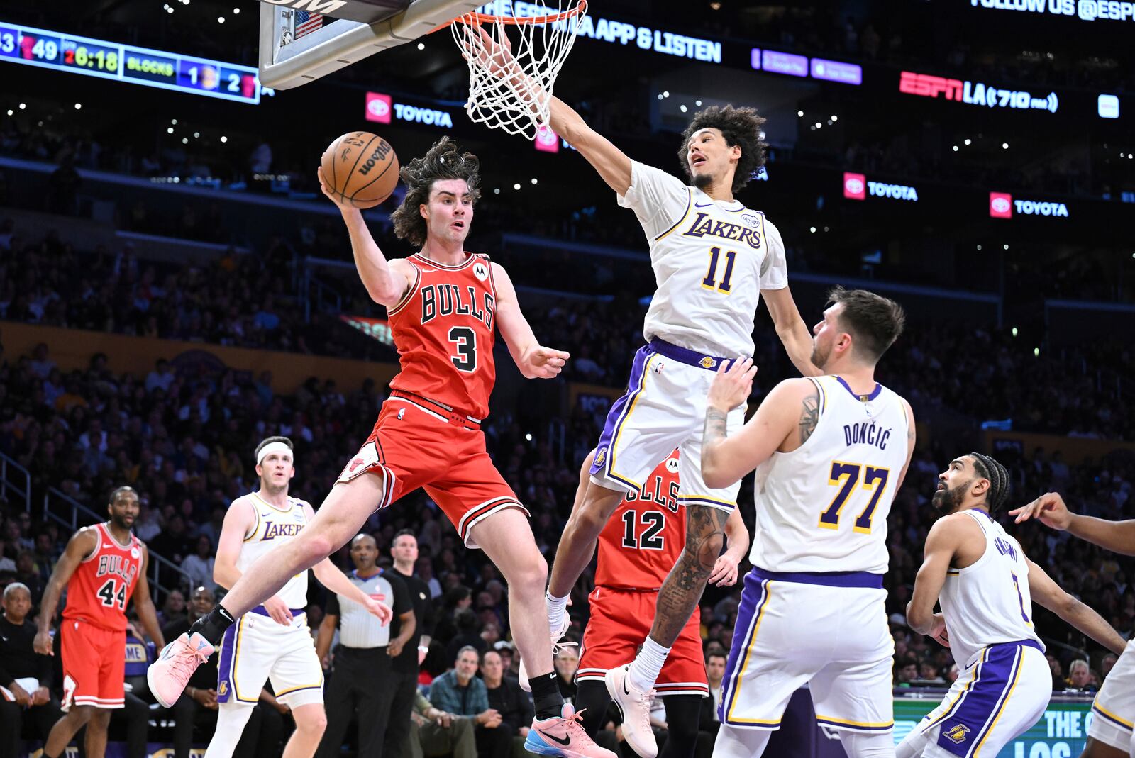 Chicago Bulls guard Josh Giddey (3) passes the ball in front of Los Angeles Lakers center Jaxson Hayes (11) and guard Luka Doncic (77) in the first half of an NBA basketball game Saturday, March 22, 2025, in Los Angeles. (AP Photo/Wally Skalij)