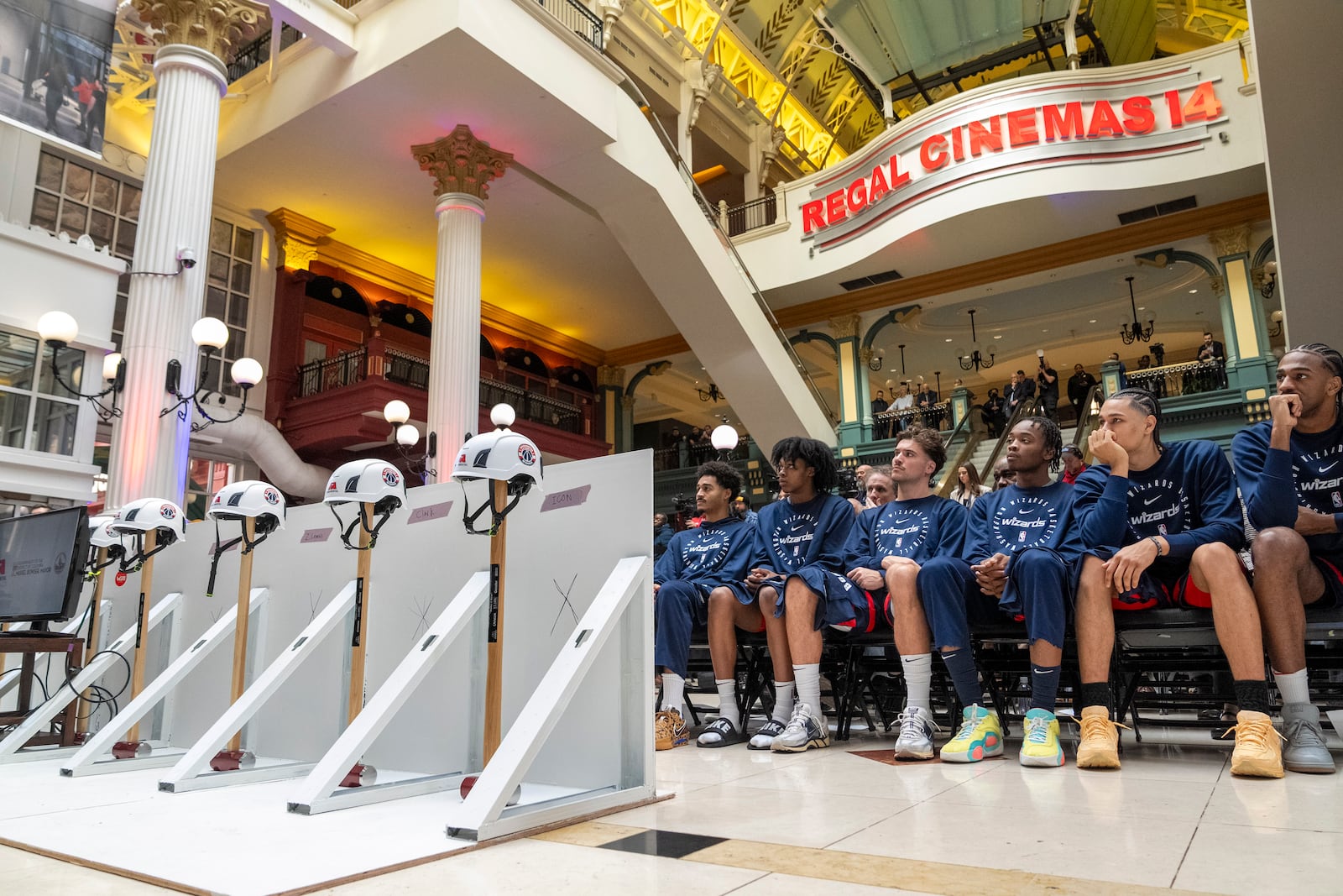 Members of the Washington Wizards NBA Basketball team listen during an event announcing the start of work on a new Capital One Arena Gallery Place Atrium, Thursday, Dec. 19, 2024, in Washington. (AP Photo/Jacquelyn Martin)