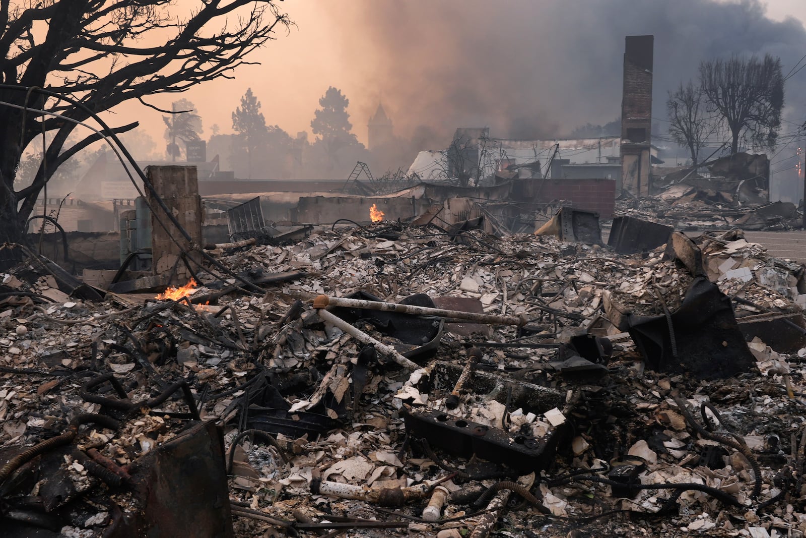 The Palisades Fire ravages a neighborhood amid high winds in the Pacific Palisades neighborhood of Los Angeles, Wednesday, Jan. 8, 2025. (AP Photo/Damian Dovarganes)