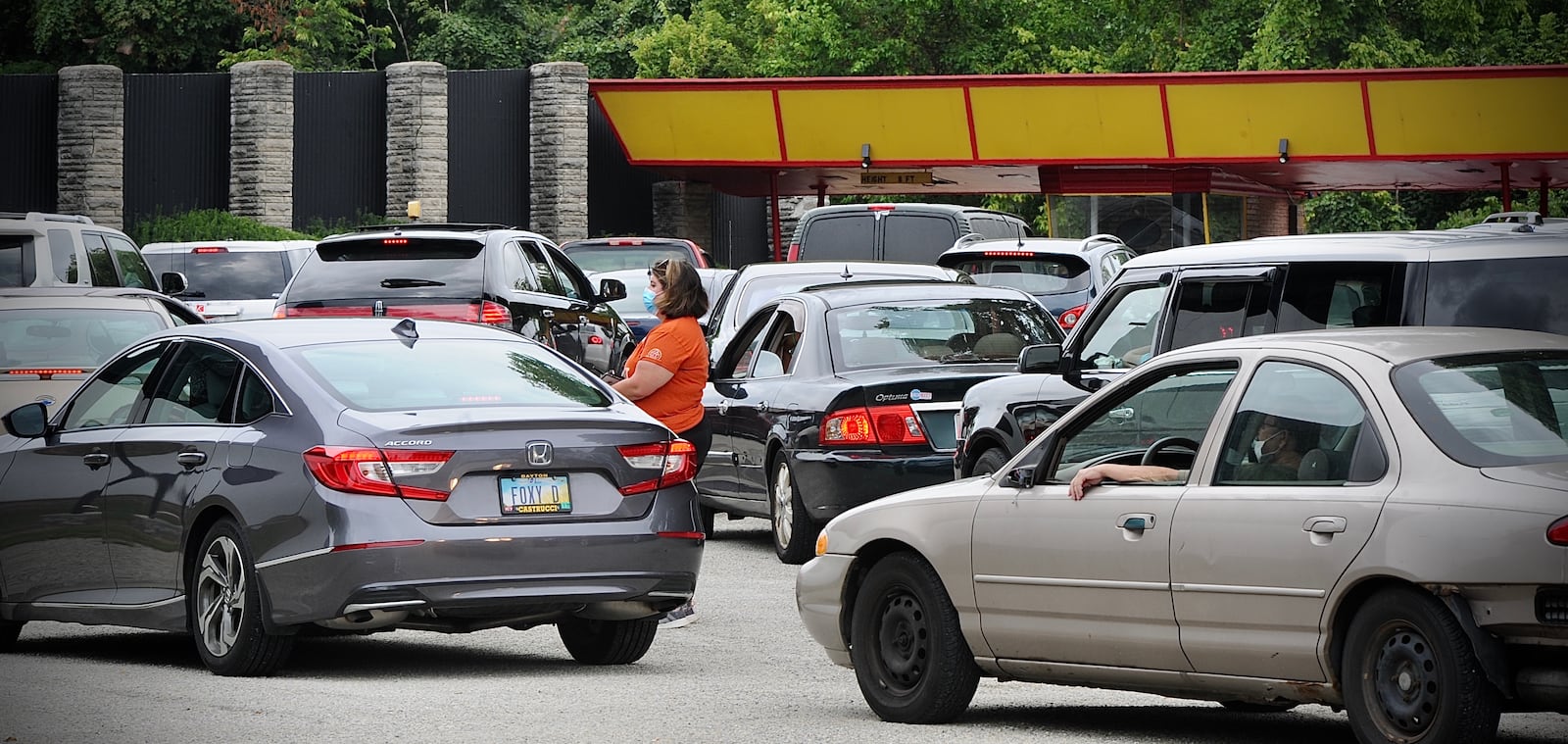 Vehicles line up to enter the Dixie Drive-In for The Foodbank's mass food distribution Tuesday, Aug. 16, 2021. MARSHALL GORBY\STAFF