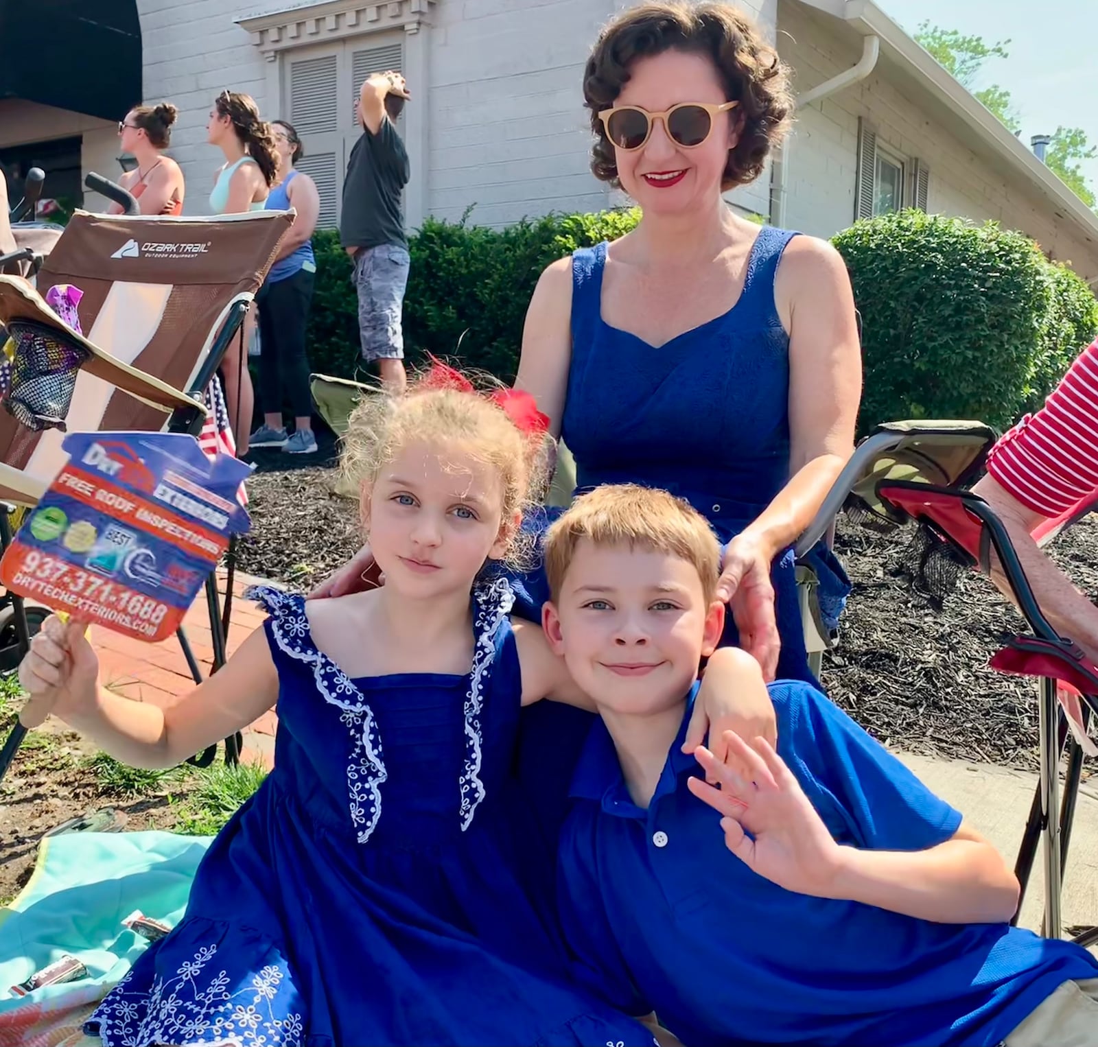 Margaret Page and her kids Clara and Bennett wave to paradegoers at the Americana Festival in Centerville, the morning of July 4, 2023. LONDON BISHOP/STAFF