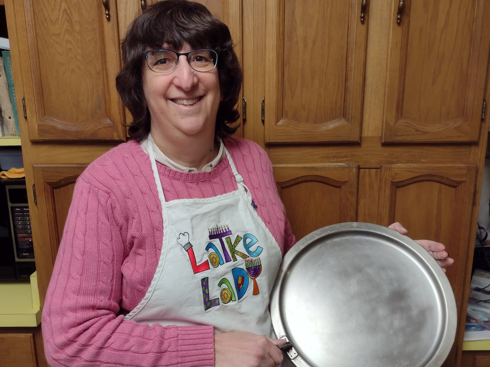 Sara Faust and her sons make potato latkes with the pan that has been handed down in the family.