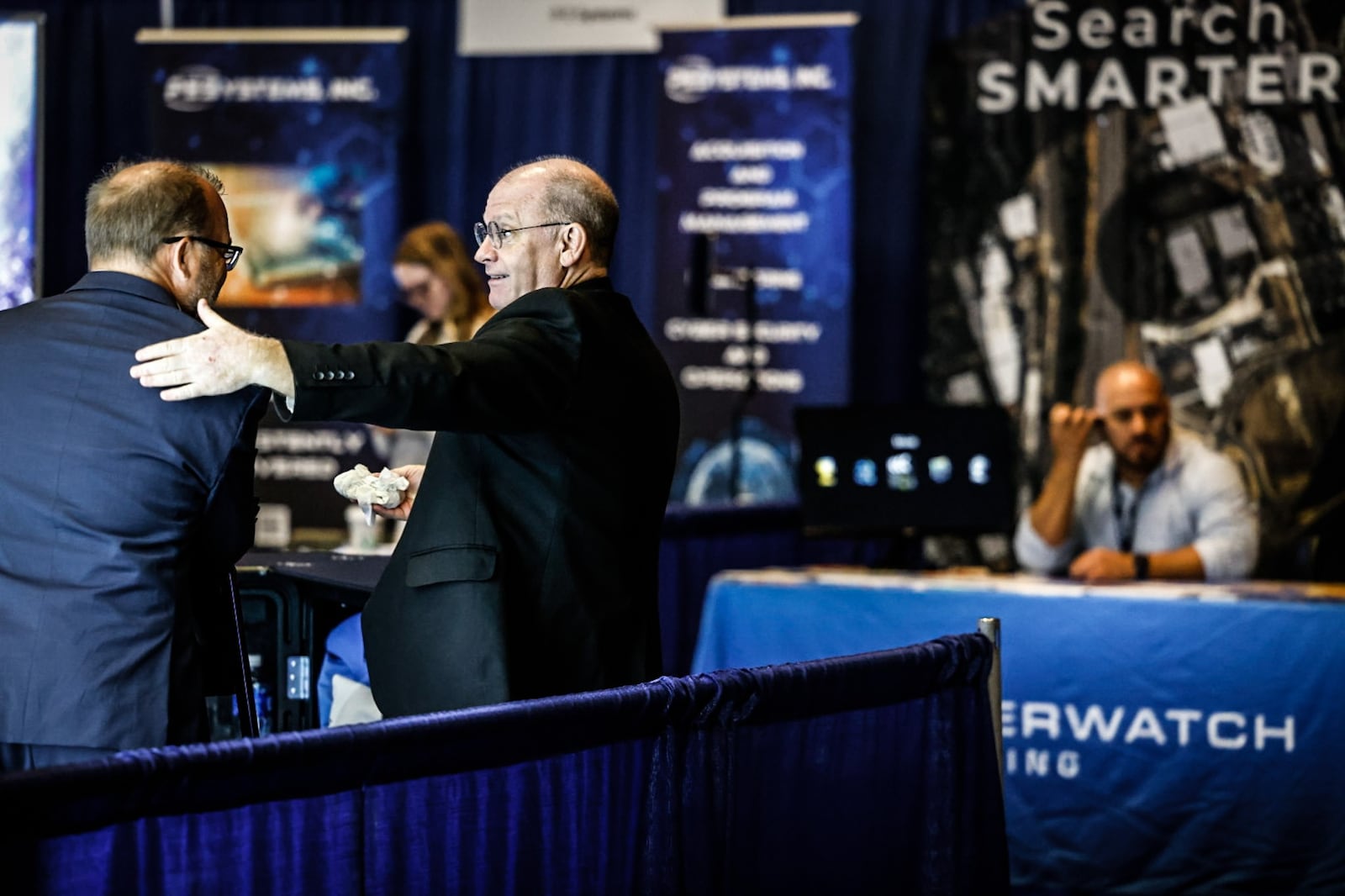 Matt Spiller left and Jeff Wallace, both from DMG MORI Federal Service greet east other at the Life Cycle Industry Days held at the Dayton Convention Center Monday July 31, 2023. JIM NOELKER