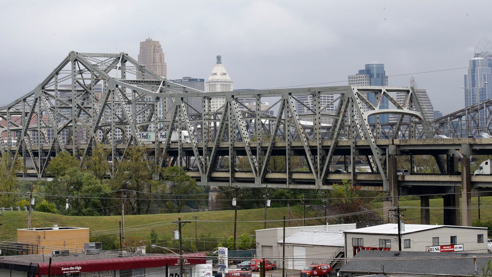 FILE - Traffic on the Brent Spence Bridge passes in front of the Cincinnati skyline while crossing the Ohio River to and from Covington, Ky., Oct. 7, 2014. AP Photo/Al Behrman, File)