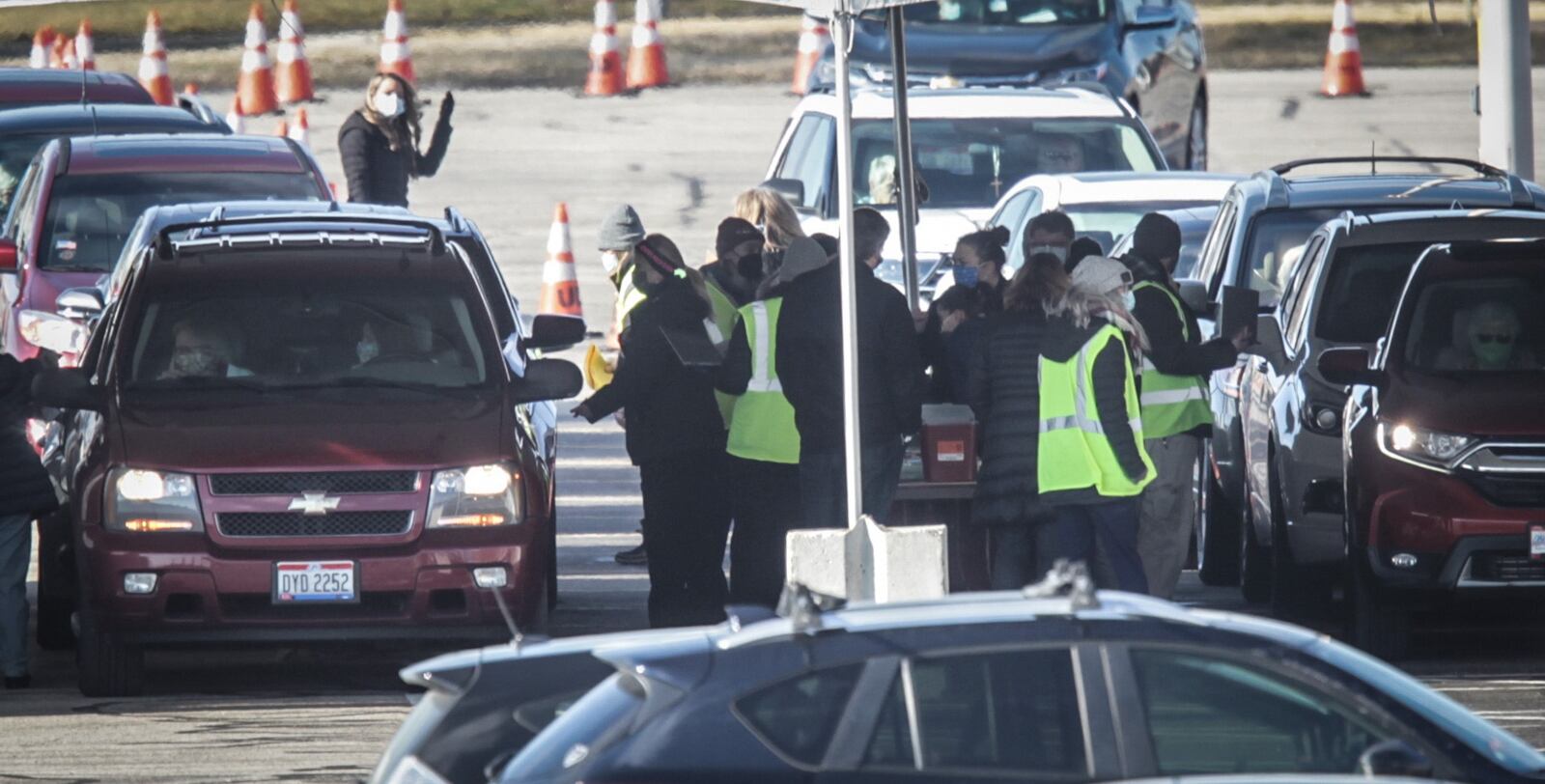 Vehicles line up at the University of Dayton Arena Wednesday  Jan. 20, 2021 for a drive thru COVID-19 vaccine distribution. .