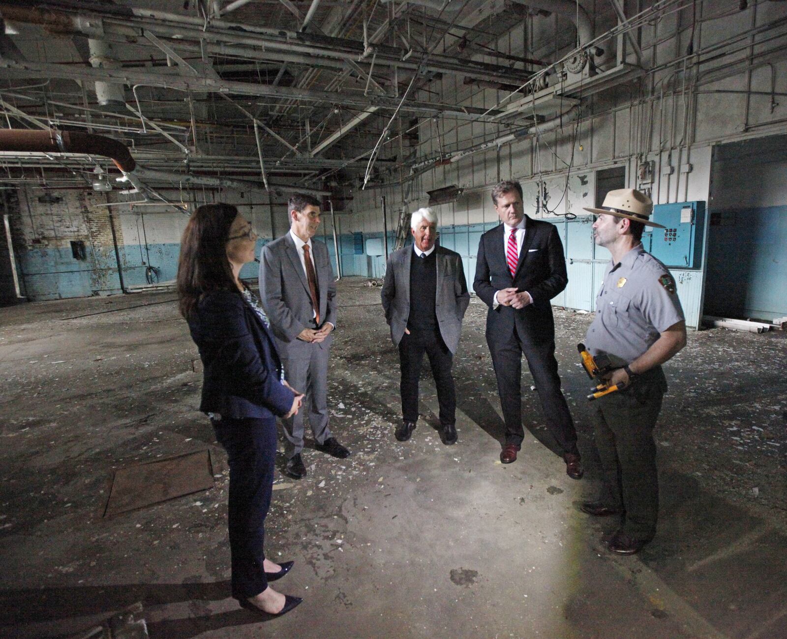 Dayton Aviation Heritage National Historical Park Superintendent Kendell Thompson, right, talks about the preservation of the first airplane factory with Congressmen Mike Turner and Chairman Rob Bishop of the House Committee on Natural Resources along with Dayton History President & CEO Brady Kress, and National Aviation Heritage Area Executive Director Mackensie Wittmer, left, at the Wright Company Factory on Wednesday. The Congressmen spoke about efforts to support National Parks and history in the Dayton region. TY GREENLEES / STAFF