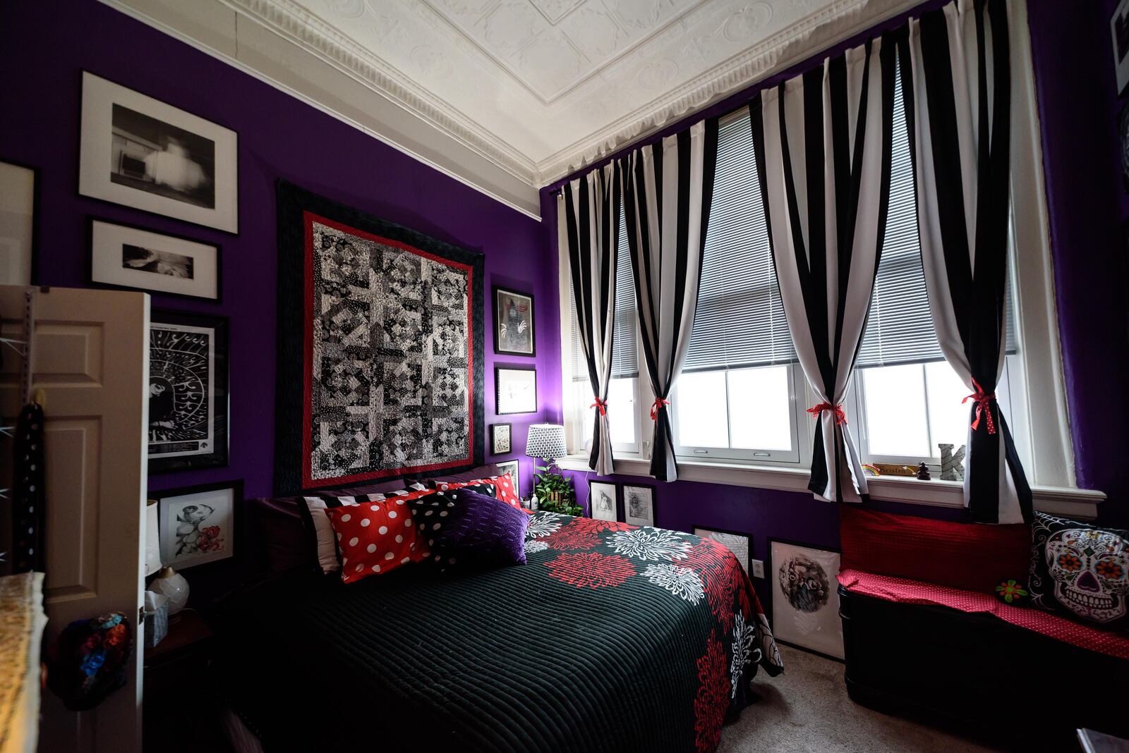 The rich purple Kristen Wicker chose became the perfect backdrop for red and black accents, including the quilt her mother crafted, now hanging above her bed. CONTRIBUTED